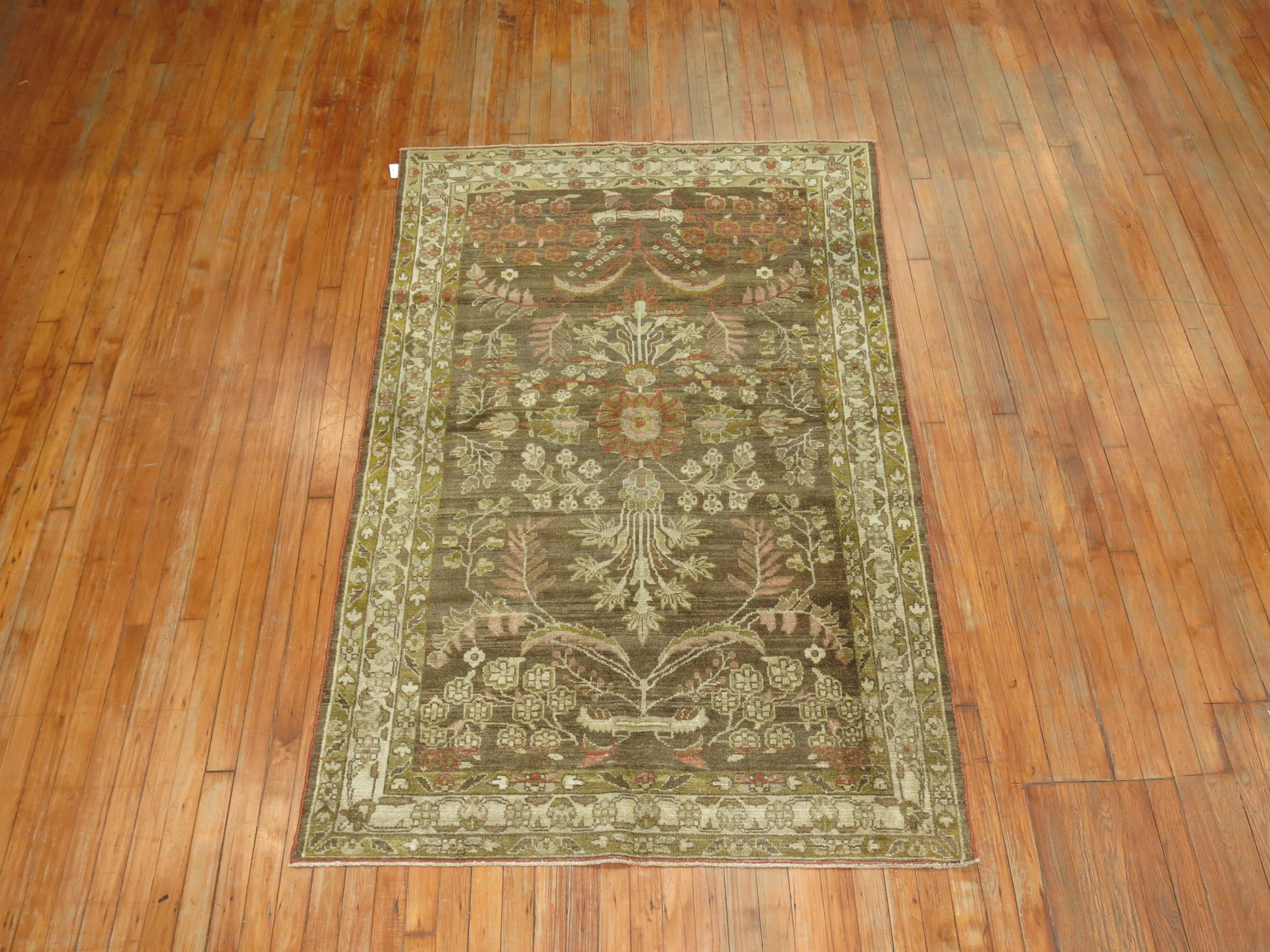 An antique Persian Malayer rug with a formal design on a brown field, copper and green accents.

Measures: 4'3” x 6'.9''.