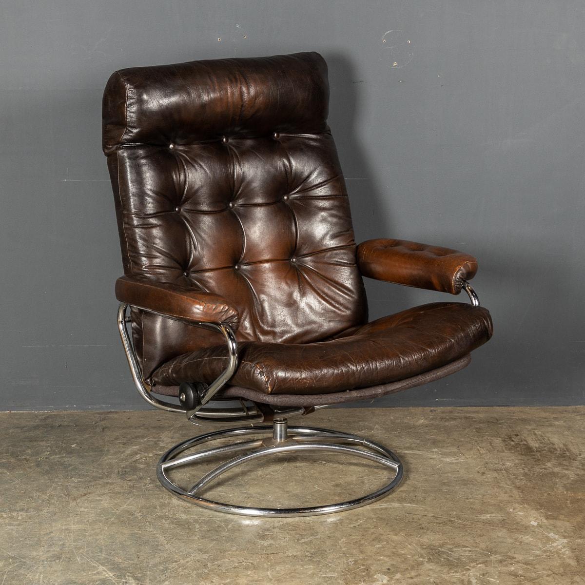 An extremely comfortable buttoned brown leather swivel chair on a circular chrome foot, with the added feature of reclining, using the mechanism on either side of the seat this chair can be locked in the desired reclining position,