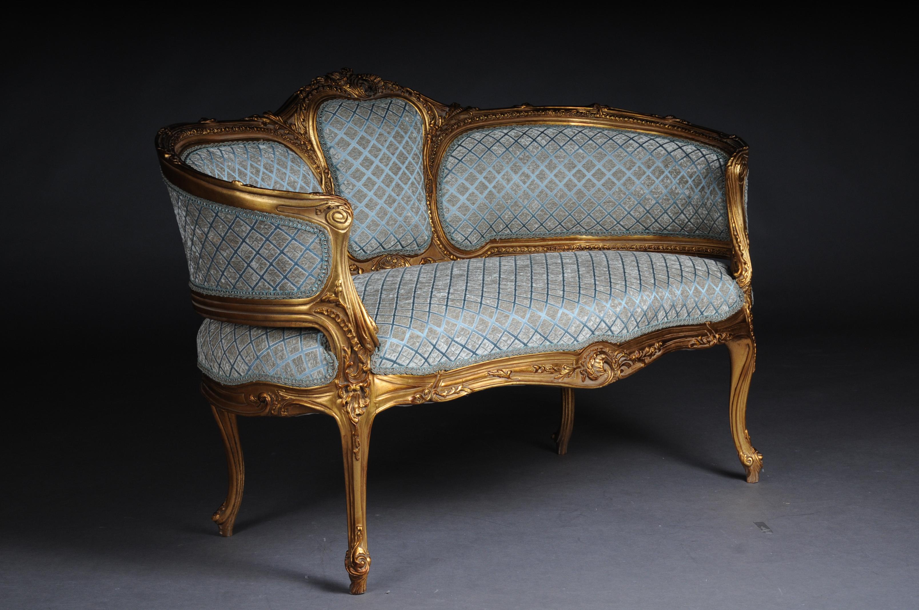 Rococo canapé 
Massive beechwood
Carved and gilded 
Pierced rocailles crowning
Frame with richly carved foliage
High quality upholstery and fabric cover.