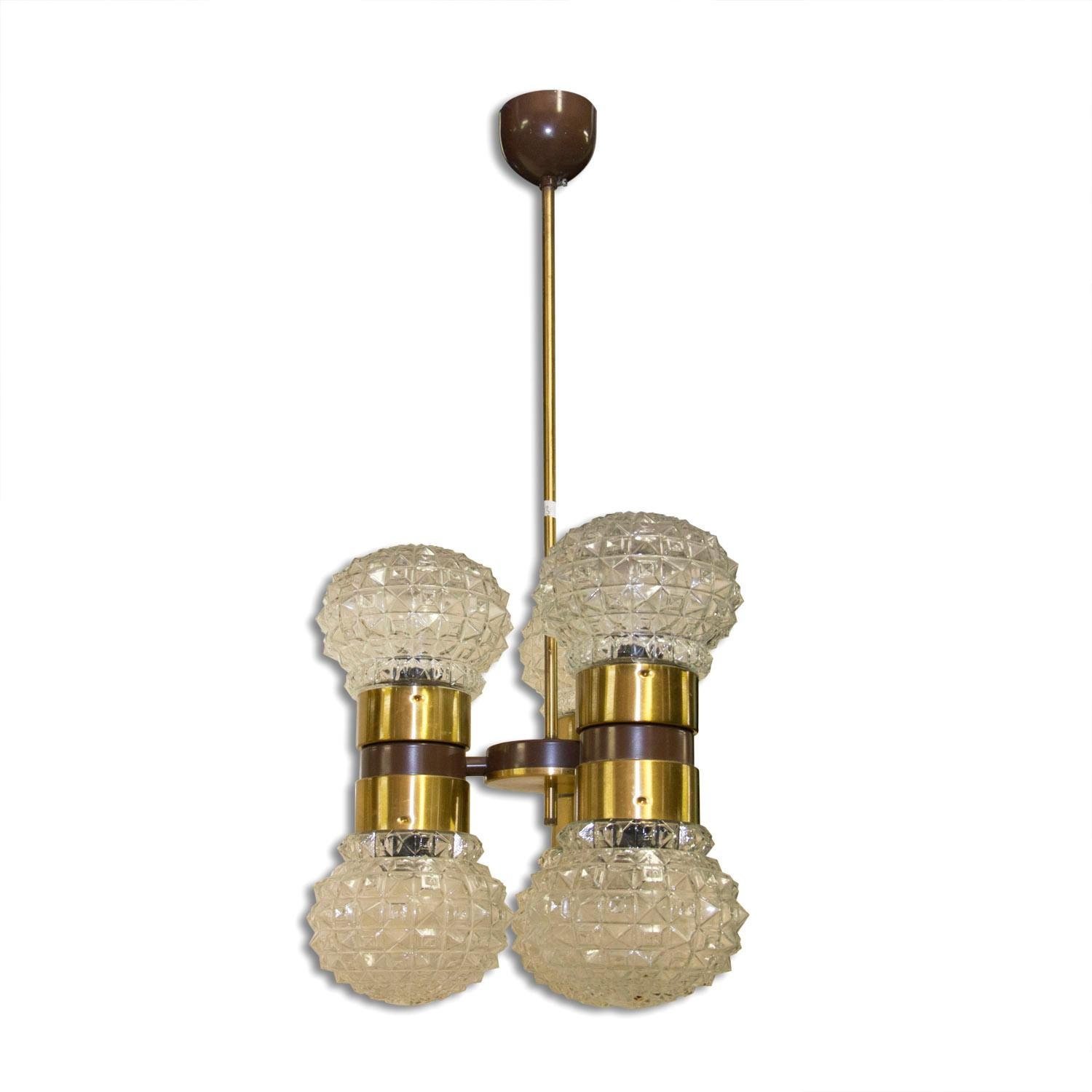 Czechoslovak cut glass and brass pendant, made in the former Czechoslovakia by Kamenický Šenov company in the 1970´s. It features brass structure and three cut glass lampshades in the shape of dumbbells. The pendant is in very good condition.
E27