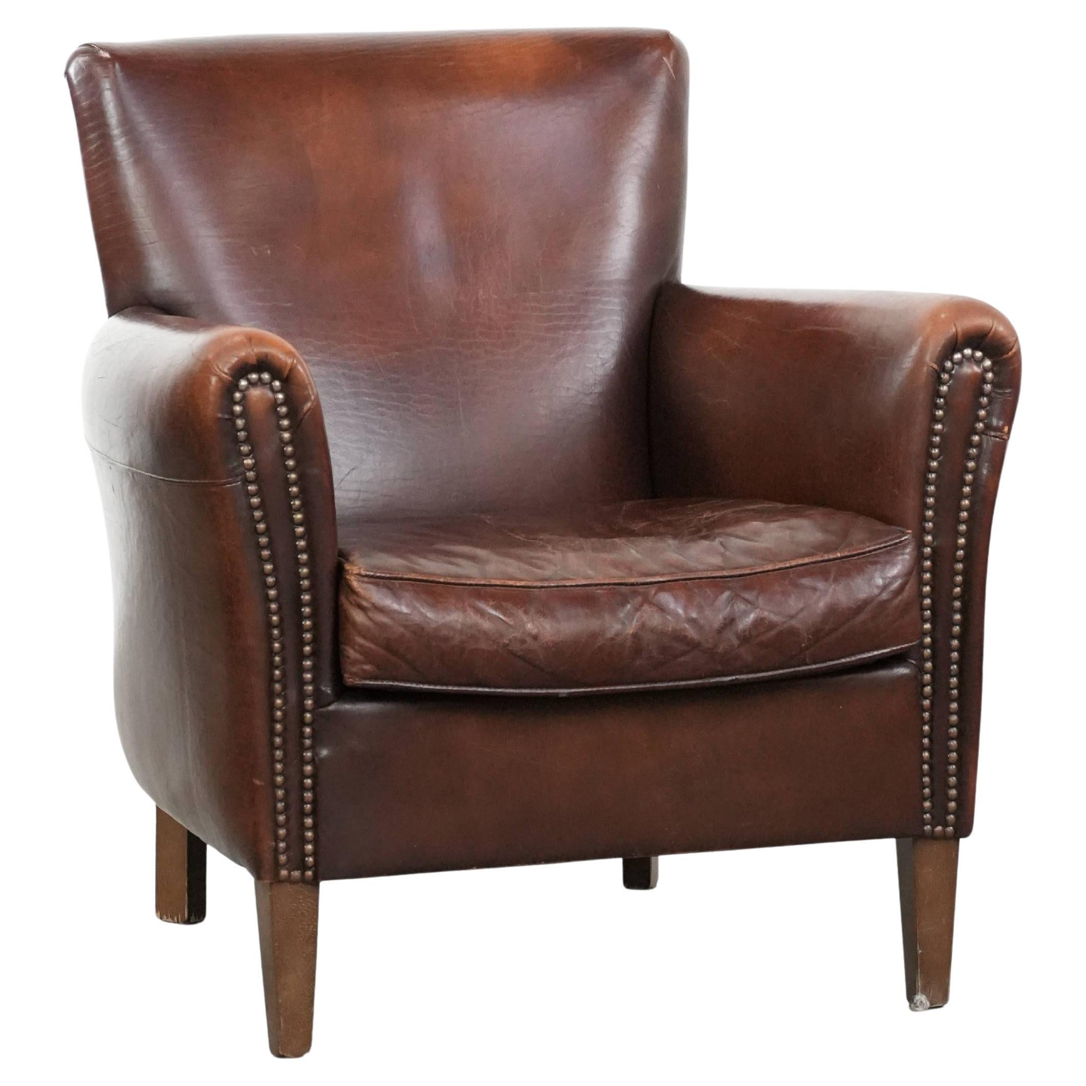 Elegant characterful vintage armchair made of sheepskin leather