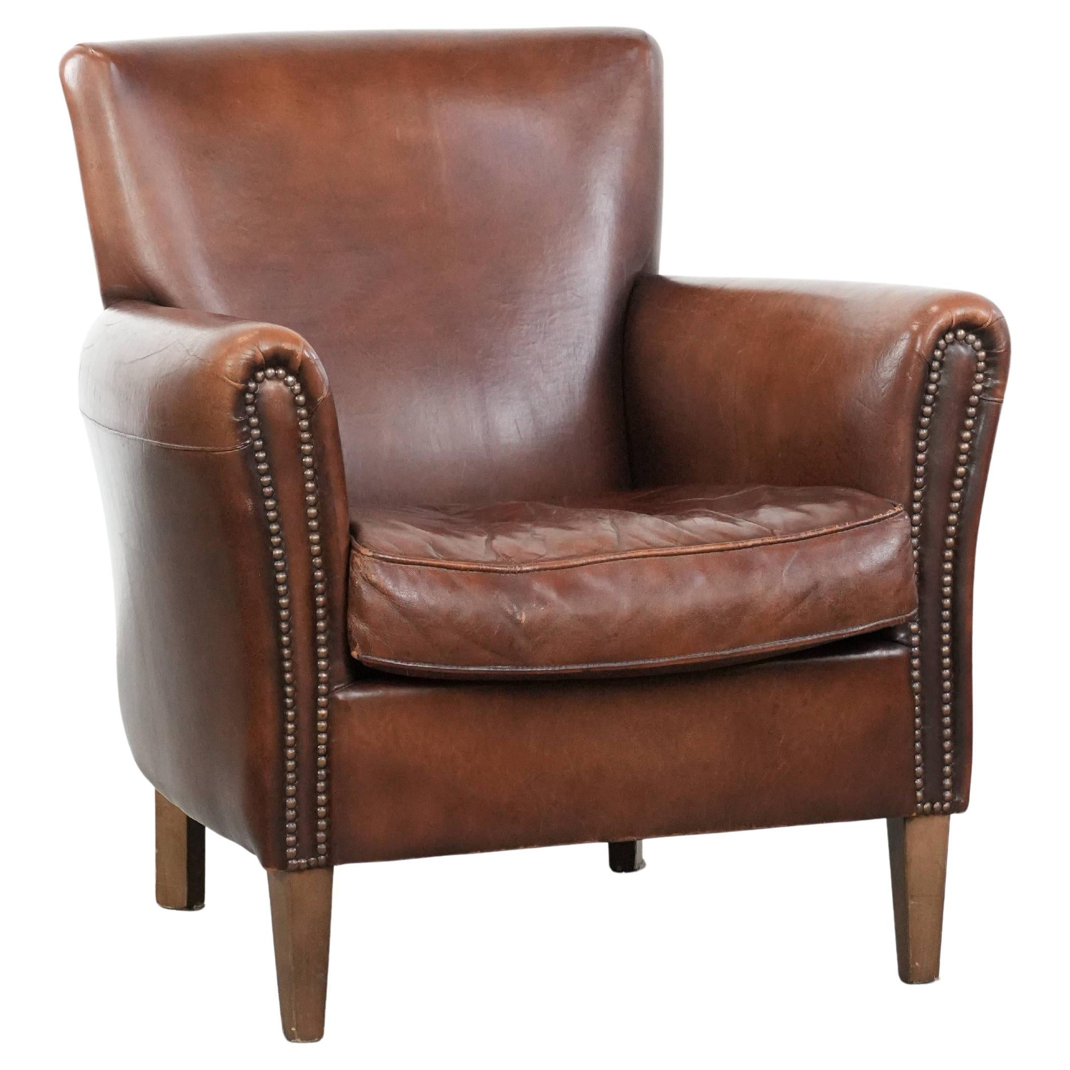 Elegant characterful vintage sheepskin armchair with beautiful warm colours For Sale