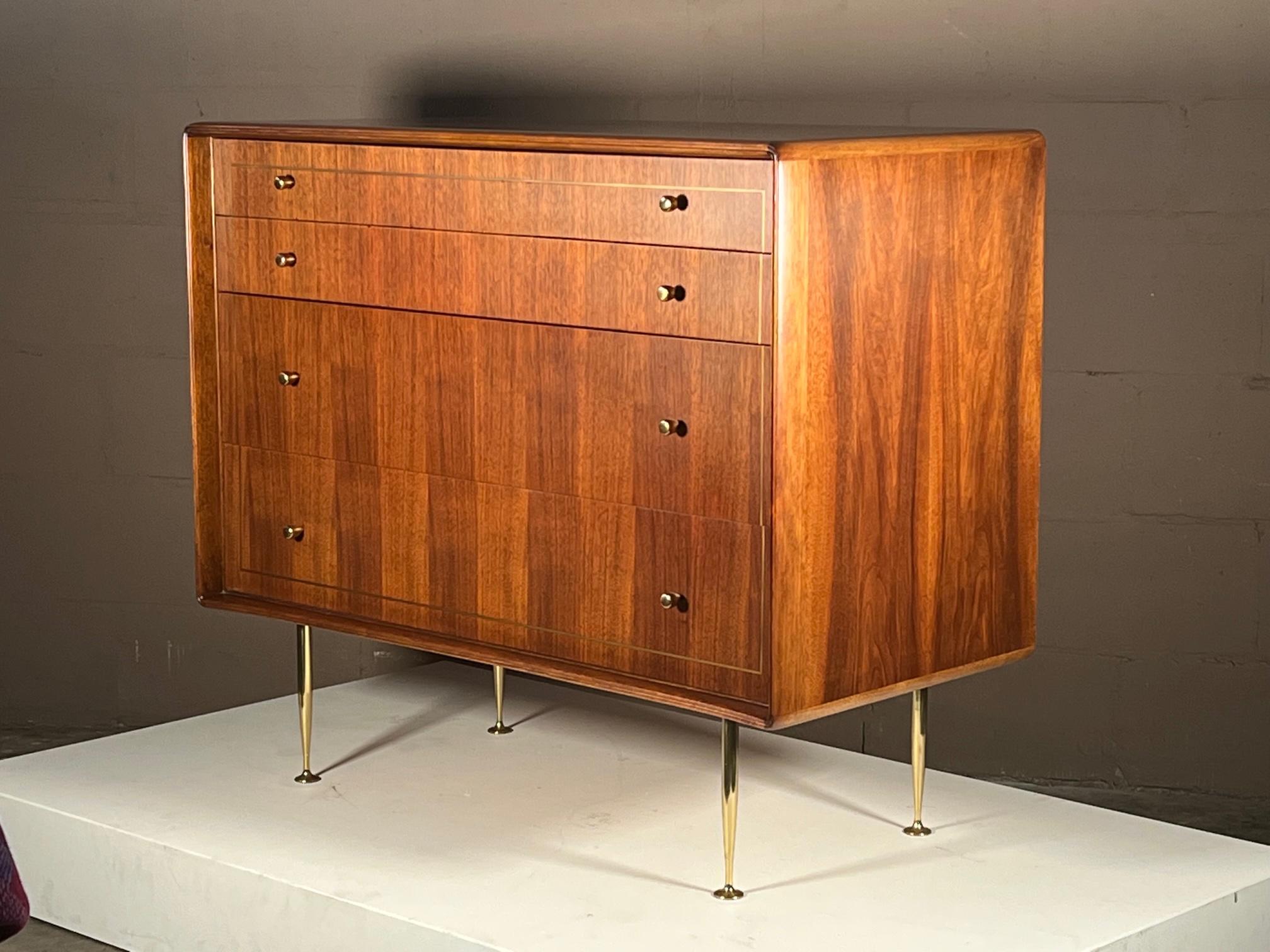 An elegant and refined chest of drawers by Erno Fabry. Made in Italy with solid brass, polished hardware and legs. Walnut construction with unusual curved front and picture frame design with brass inlay in the front drawers. Completely restored and