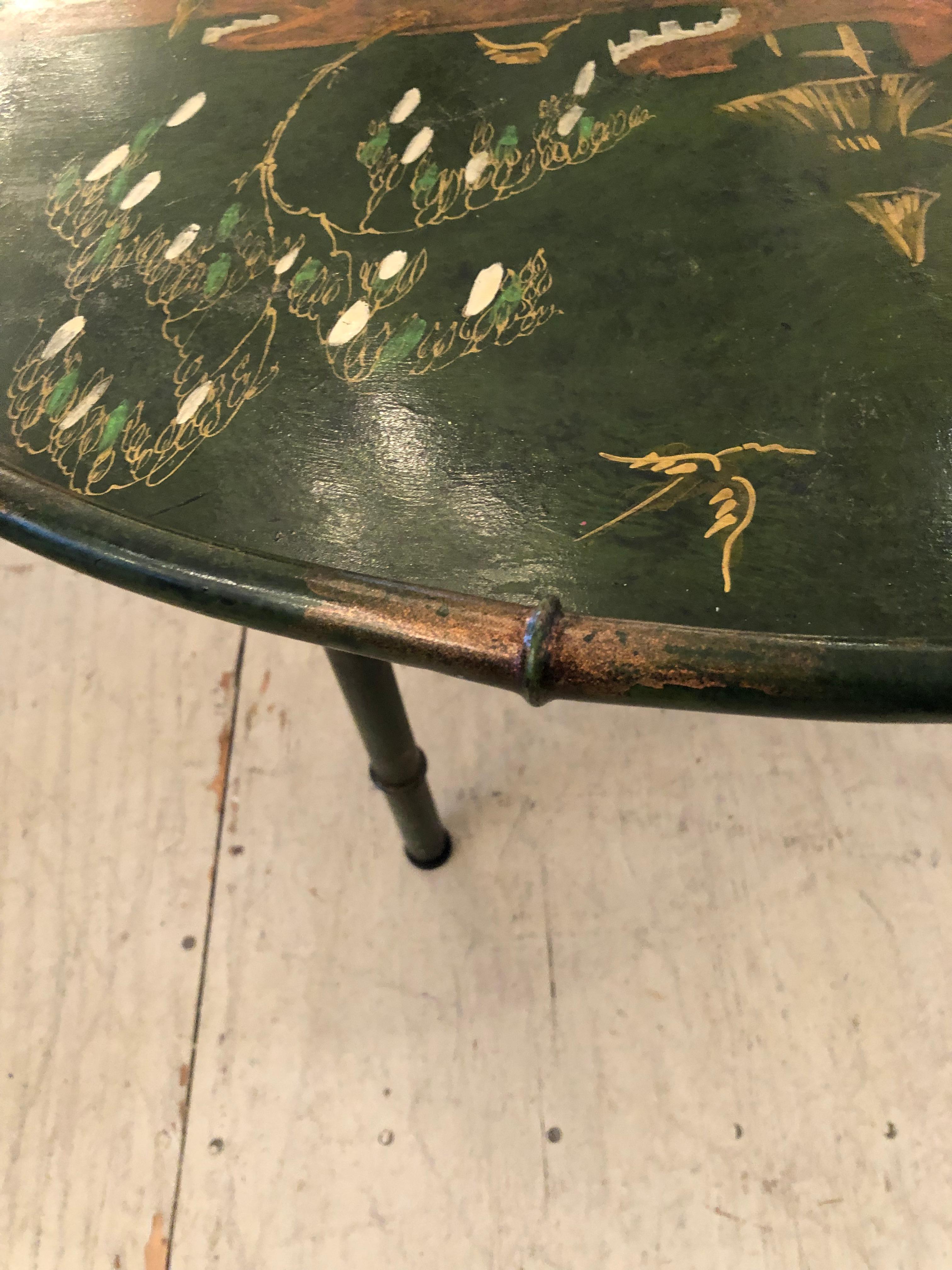 Beautiful tray top Chinoiserie decorated coffee table having unusual dark green background with burnt orange figural decoration and handsome earth color faux bamboo border, base and handles.