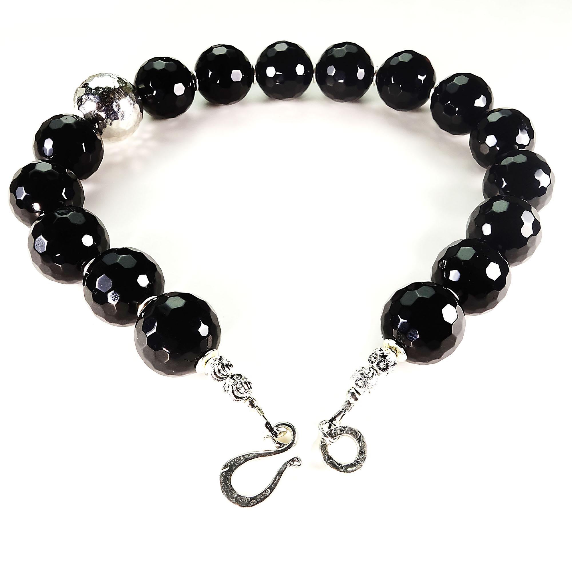 15.5 Inch, unique, handmade choker necklace of highly polished faceted Black Onyx with an off-center focal of faceted Pure Silver.  The Black Onyx is 18MM and the Pure Silver focal is 20MM.  This short choker sits on your neck and inside an open