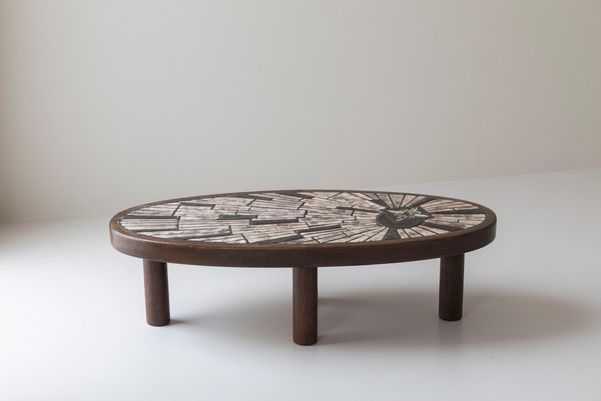 Elegant coffee table by Barrois for Vallauris, France 1960s. With a beautifully dark-stained oak base and a bold, sculptural form, it combines the richness of wood with the artistic flair of glazed ceramic. The result is a table that is as