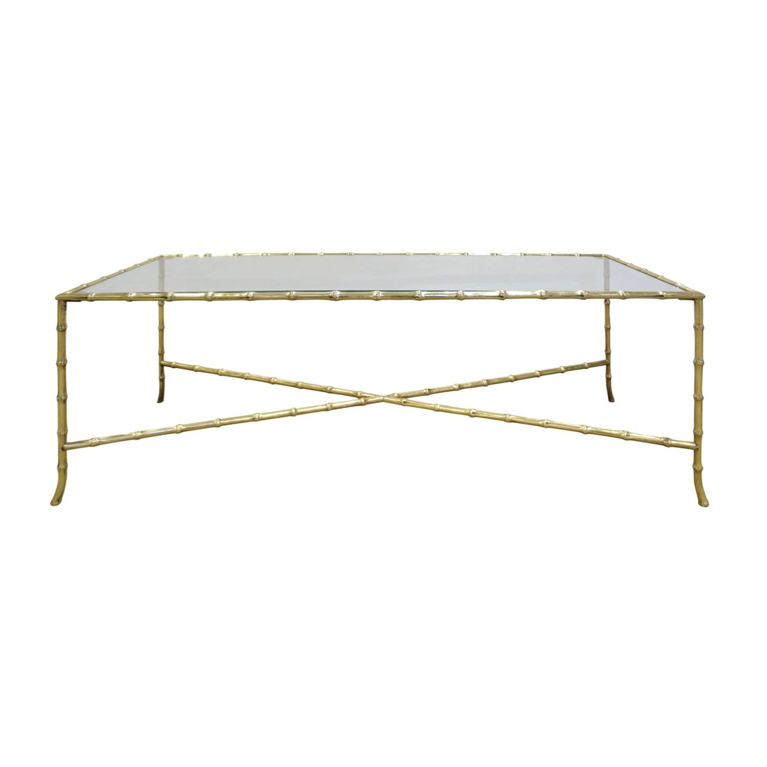 Elegant coffee table in brass with bamboo motif with cross stretchers and inset glass, American 1950s.