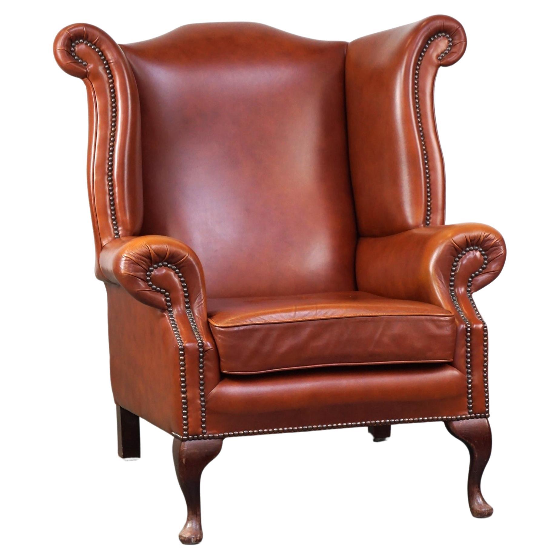 Elegant, comfortable English Chesterfield wingback armchair, cowhide leather