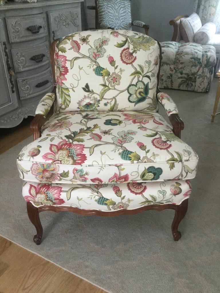 Charming pair of French style arm chairs having mahogany scalloped frame, cabriole legs, and wide and deep seats. You will love the gorgeous colors in this English-country inspired fabric with multiple shades of green and pink on a white background.