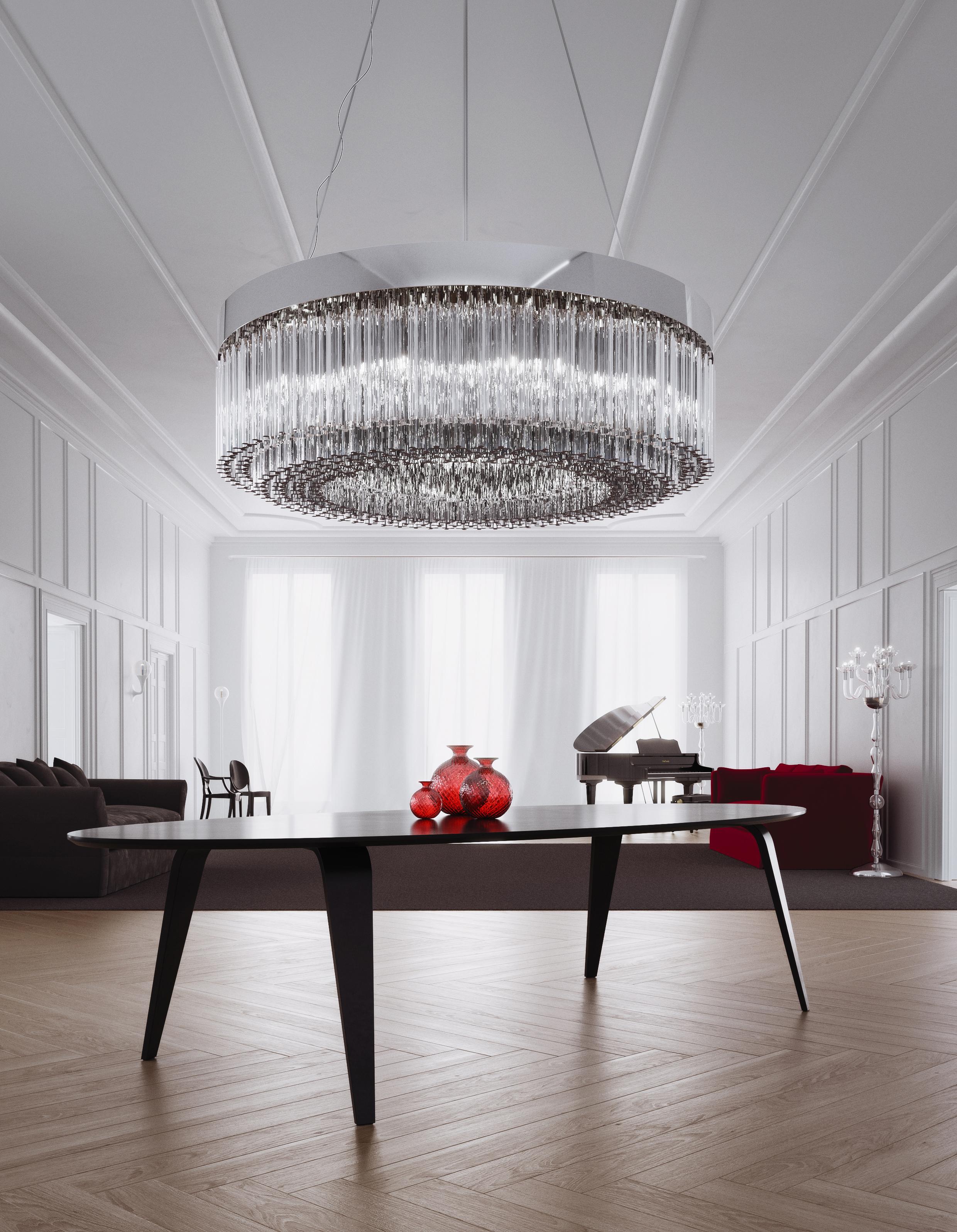 963.12 Crystal color glass.
Circular chandelier composed of handcrafted “Trilobi” modules in solid cristallo glass, hung from a chrome-plated structure suspended from steel cables.
Characterised by a shape the section of which recalls the three