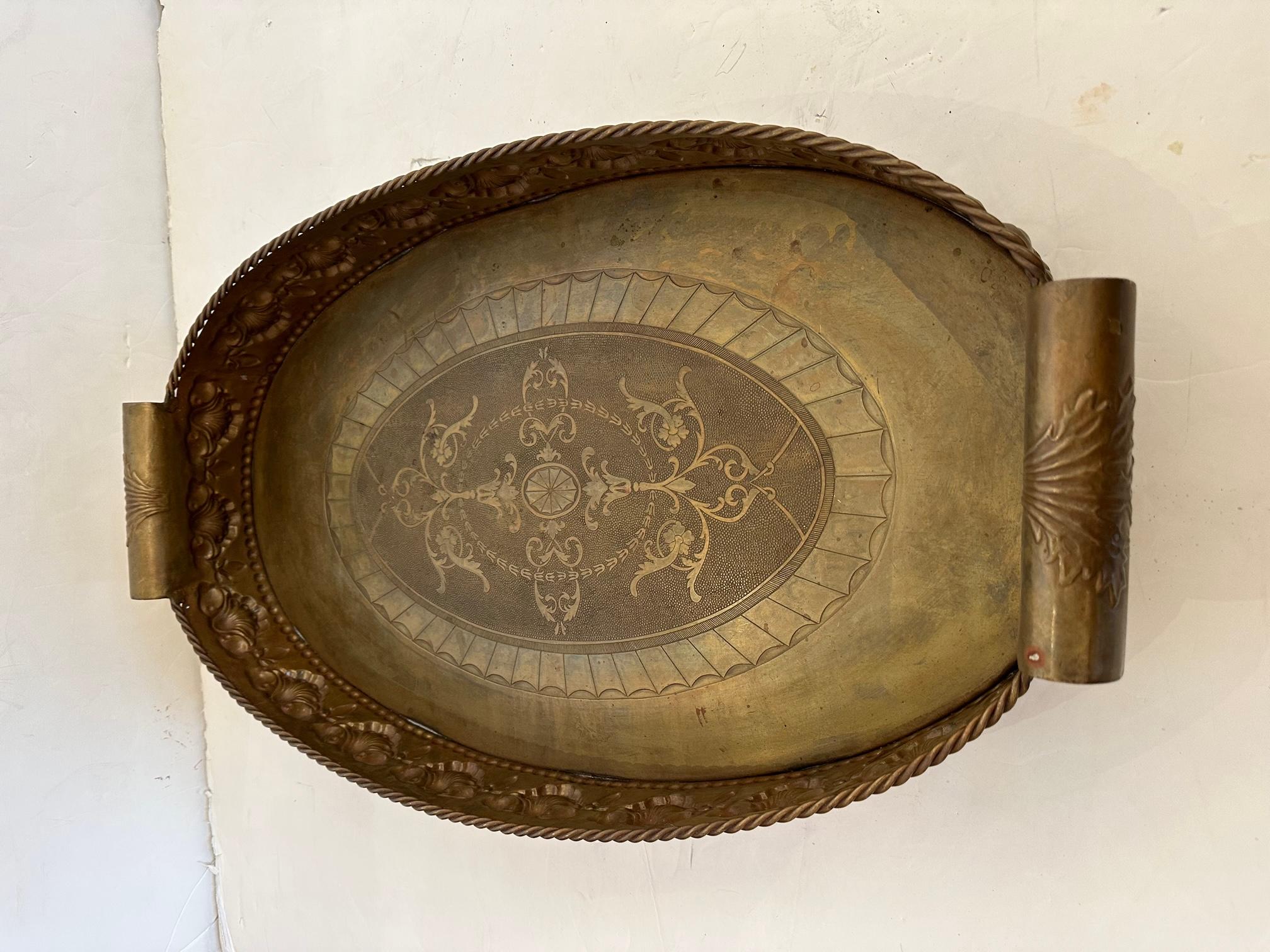 Elegant large and deep oval brass tray with ornate gallery and chunky handles.