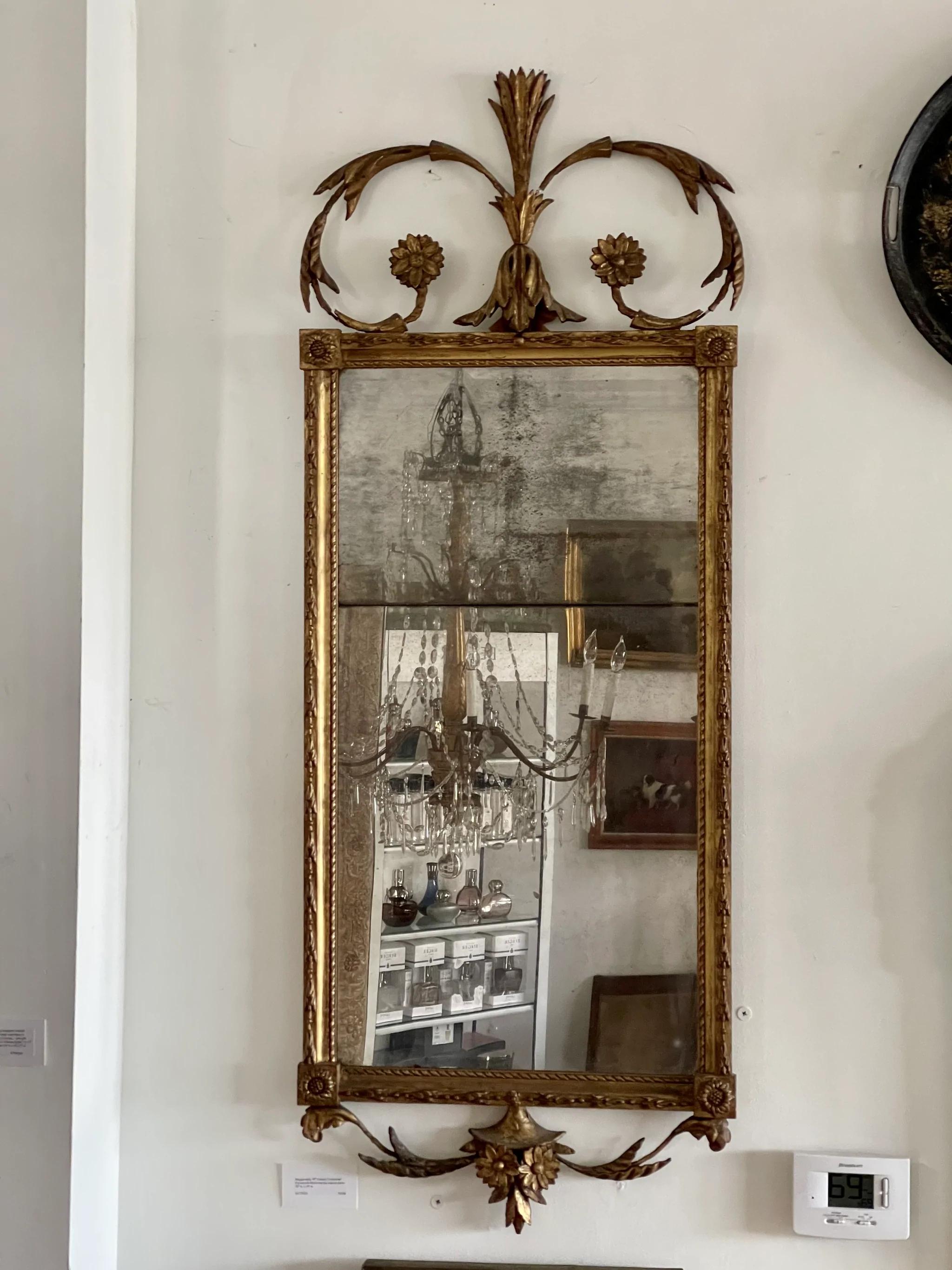 Elegant Continental Baroque Carved and gilded mirror,French or Italian, 18th century, well carved frame set with leaf, rocaille, and rosette ornament in deep relief, rectangular mirror plate.