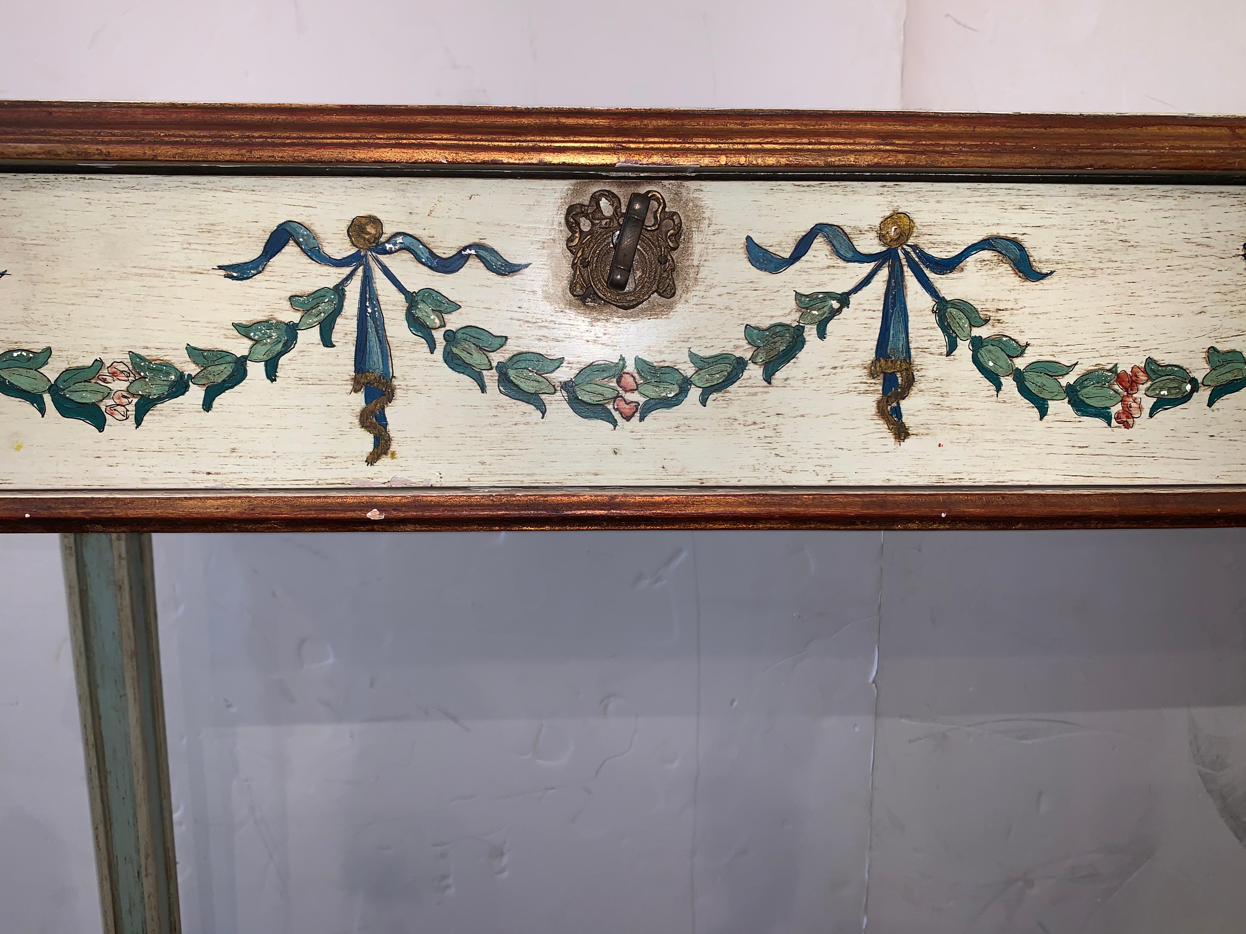 Beautiful hand painted vintage console having cream background and lovely neoclassical garlands in celadon green, gold, blue, red. The two drawers have a brass key and the interior or the drawers are painted a lovely turquoise.
   