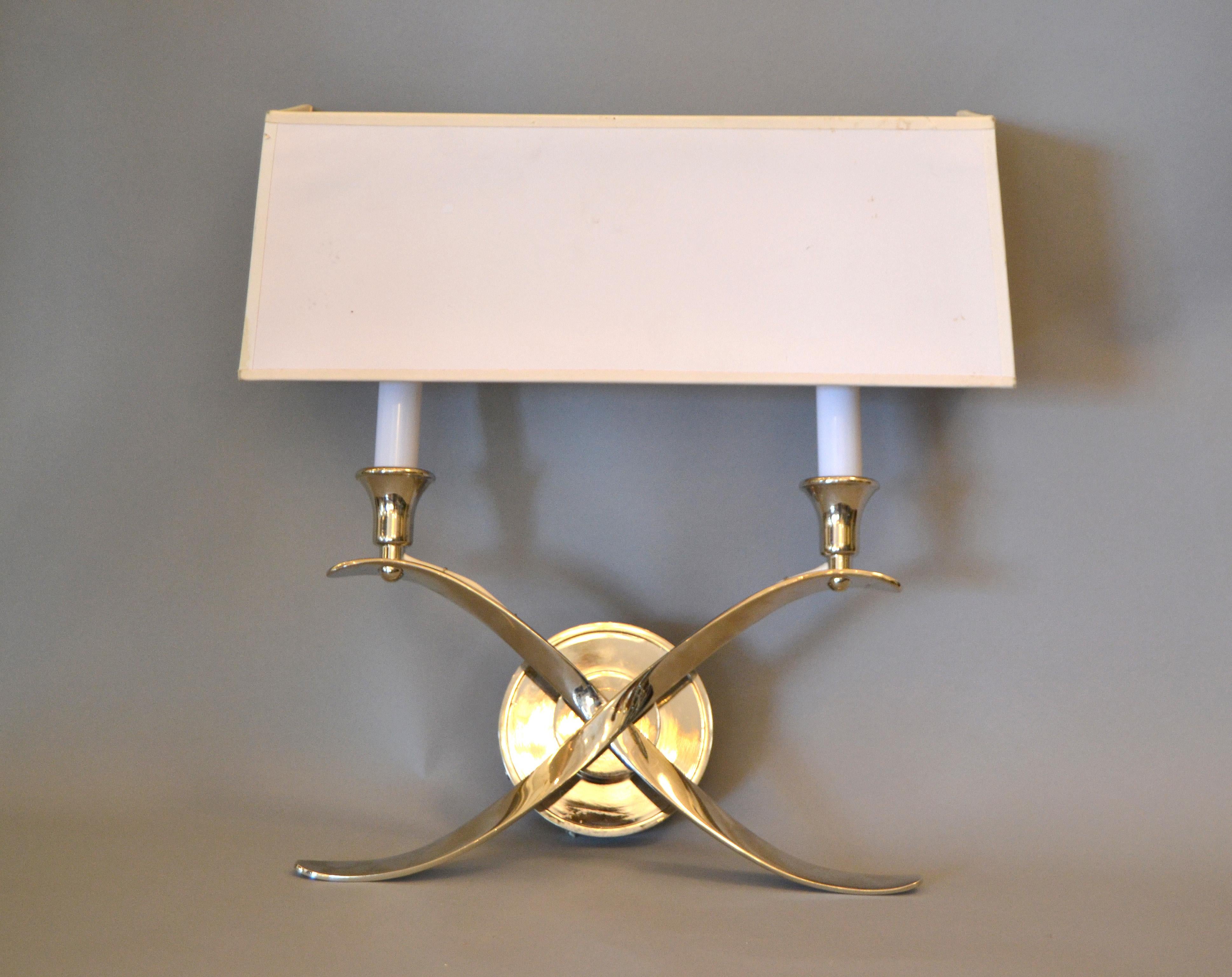 A pair of modern stainless steel double sconces designed with clip on paper shades.
Elegantly crossed scrollwork that holds two candle-style lights, each uses 2 candelabra light bulbs with max. 40 watts.
The pair is a stunning accent for Classic