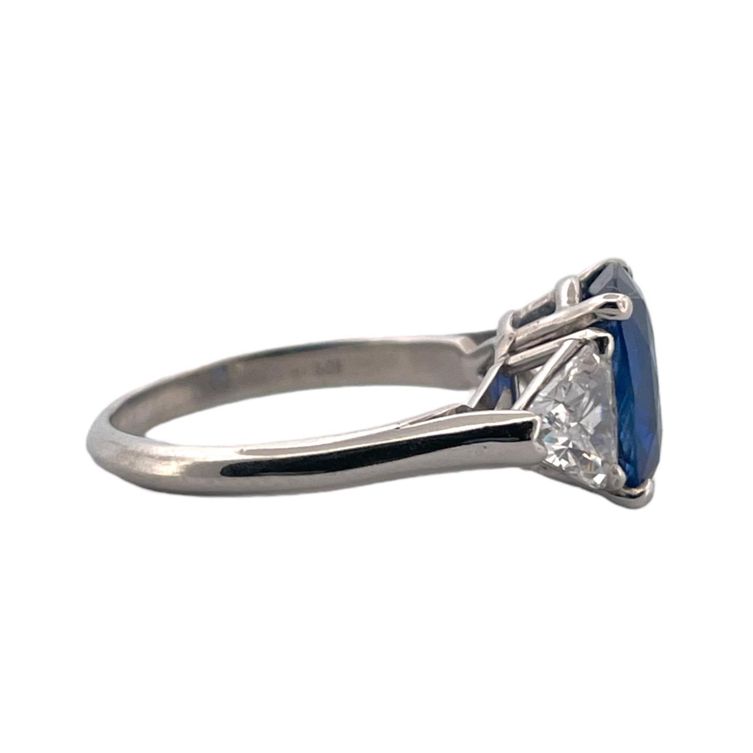 A luxurious 2.59 Carat Ceylon sapphire ring, heated to perfection, paired with 1.5 Carat of D color, VS clarity trillion cut diamonds. Set in a platinum band, size 5.5, showcasing a stunning cornflower blue hue, this ring is a treasure of