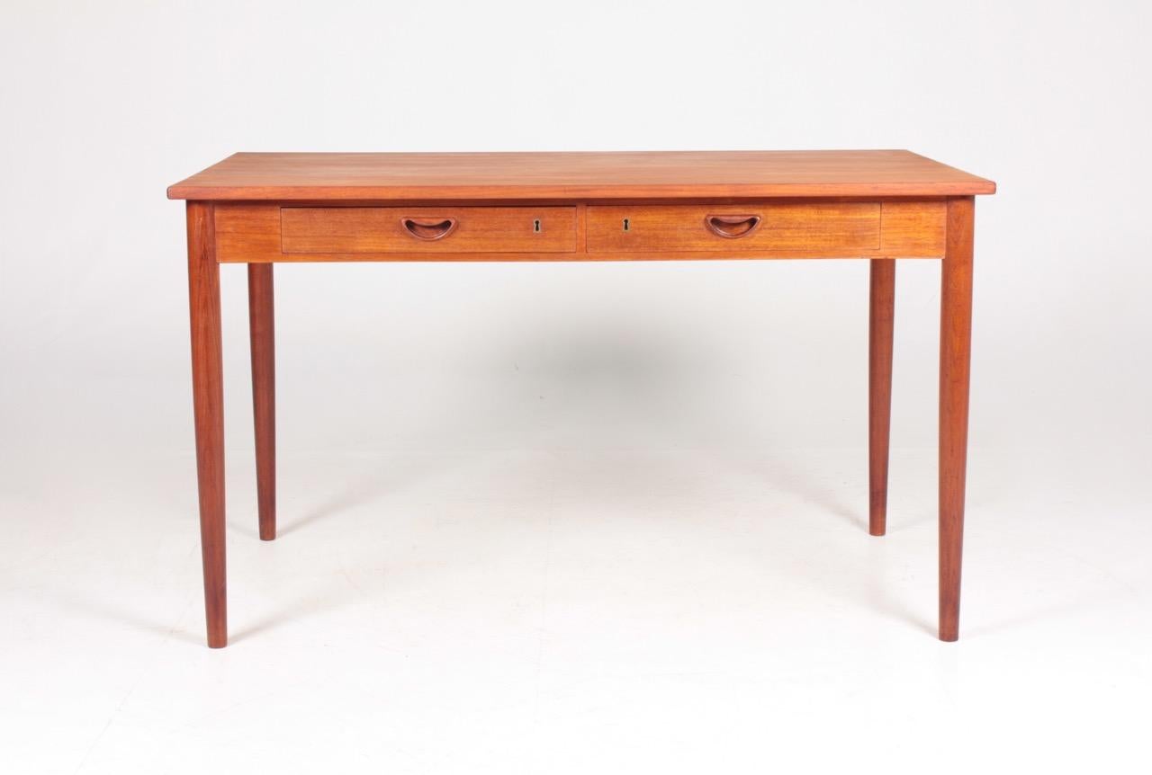 Elegant freestanding desk in teak designed by Peter Hvidt and Orla Mølgaard for Søborg furniture in Denmark.