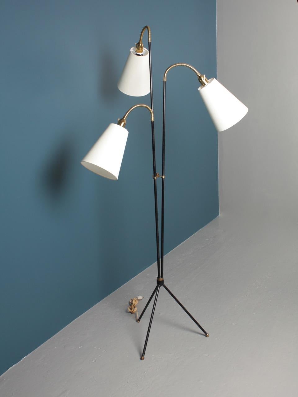Great looking floor lamp in black painted metal and brass. Comes with new fabric shades. Designed and made by Holm Sorensen in the 1950s made in Denmark.