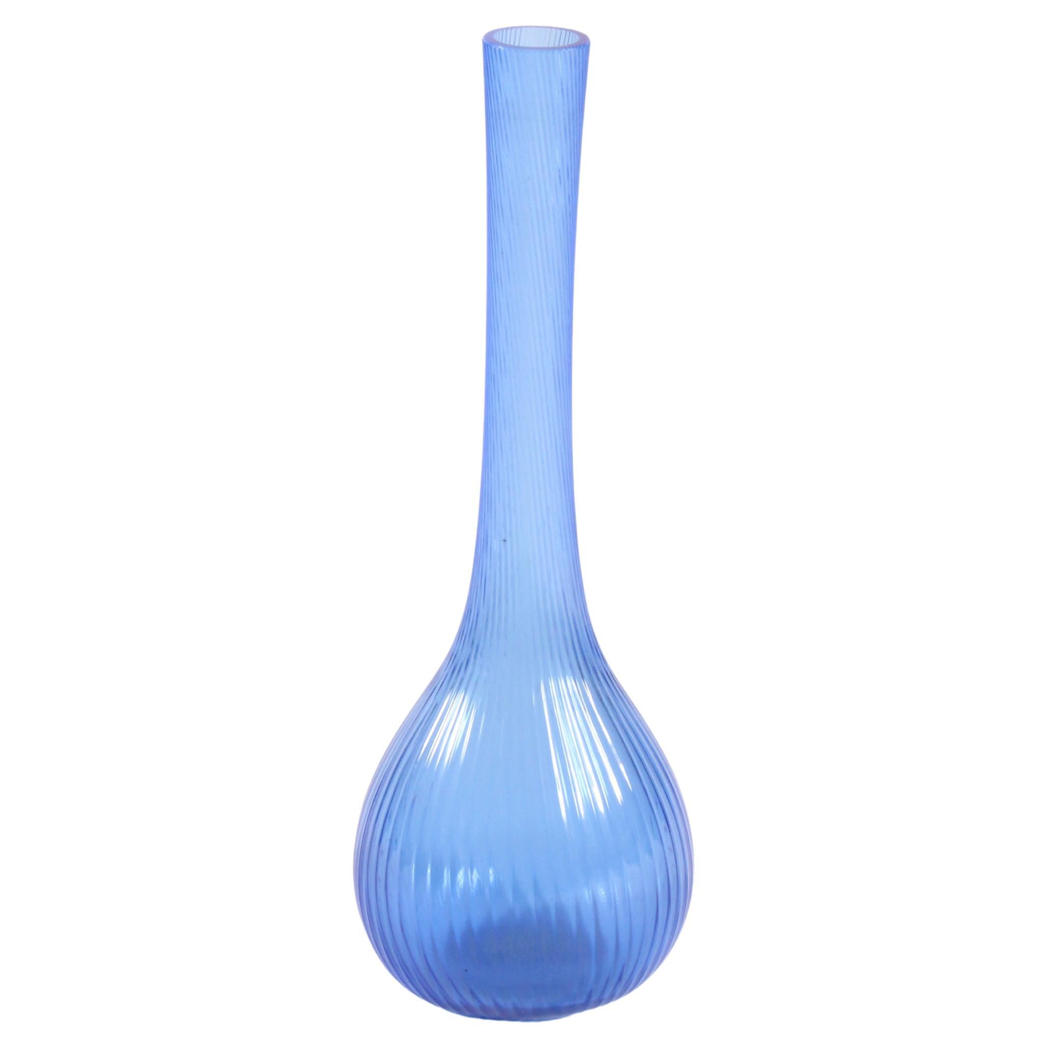 An exquisite example of French glass artistry, this elegant ribbed glass vase by the renowned Daum of France is a testament to refined design and expert craftsmanship. Signed Daum France, the piece features a unique and sculptural silhouette,