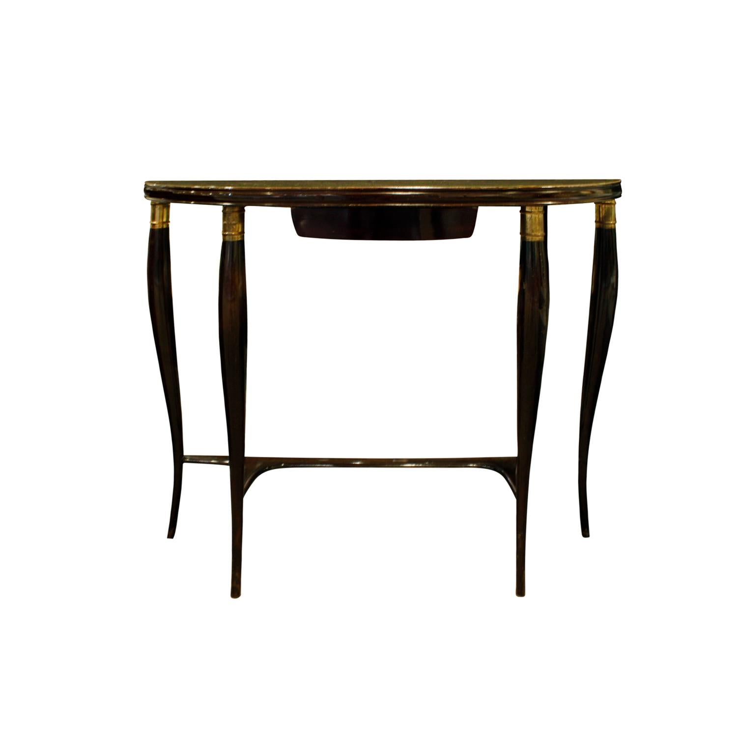 Elegant demilune shaped console table in mahogany with brass fittings and gold leaf glass top, Italy, 1950s. The gold leaf is applied to the underside of the glass. This table has a single drawer.