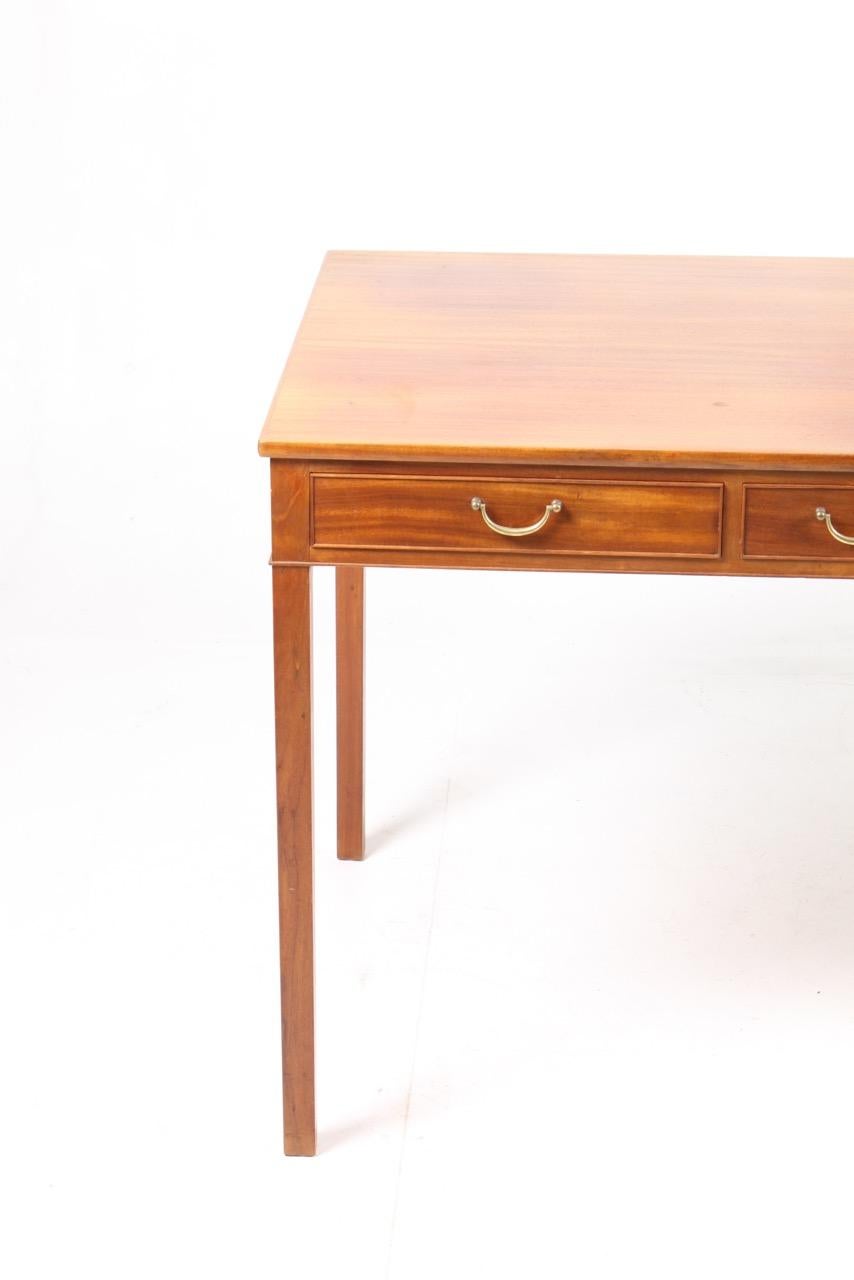 Elegant freestanding Danish design desk in mahogany with three drawers designed by Ole Wanscher for A.J. Iversen in the late 1950s. Made in Denmark, great original condition.