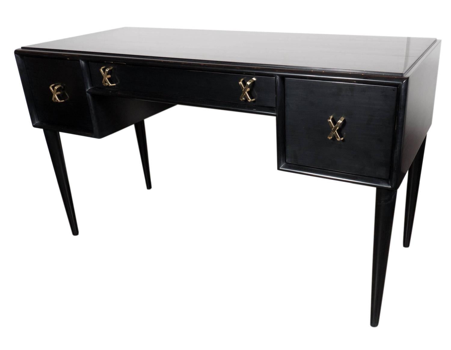 Elegant desk or vanity designed by Paul Frankl for Johnson Furniture, American, circa 1950s. It has been refinished in a black lacquer finish. This piece is a versatile size and can be used as a desk, vanity, console table, or bar. It is finished on