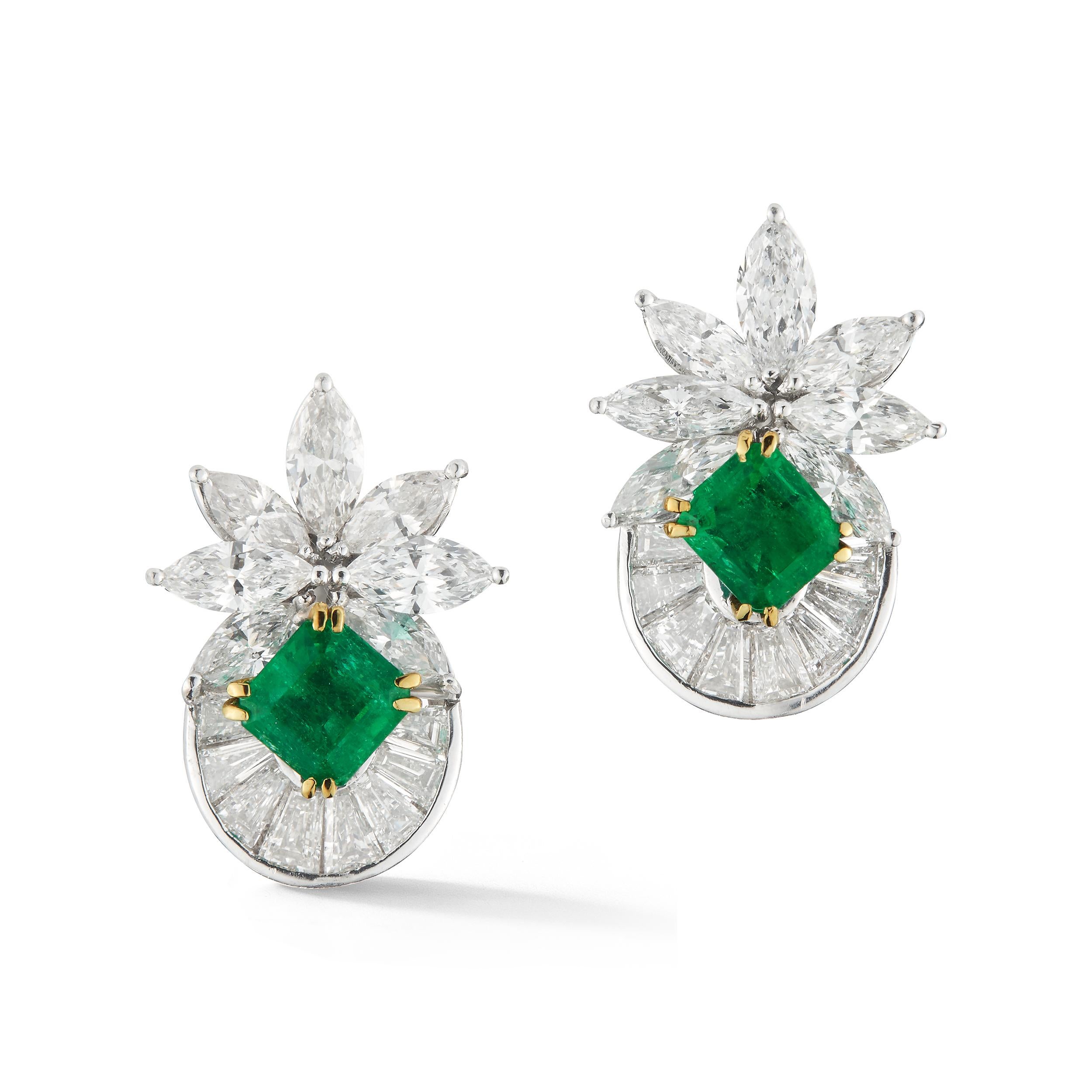 Elegant Diamond and Emerald Earrings, Set with 5 carat of Marquis shaped Diamond plus 5 carat of Baguettes shaped Diamonds. in the center the Earrings are set with two Emeralds.