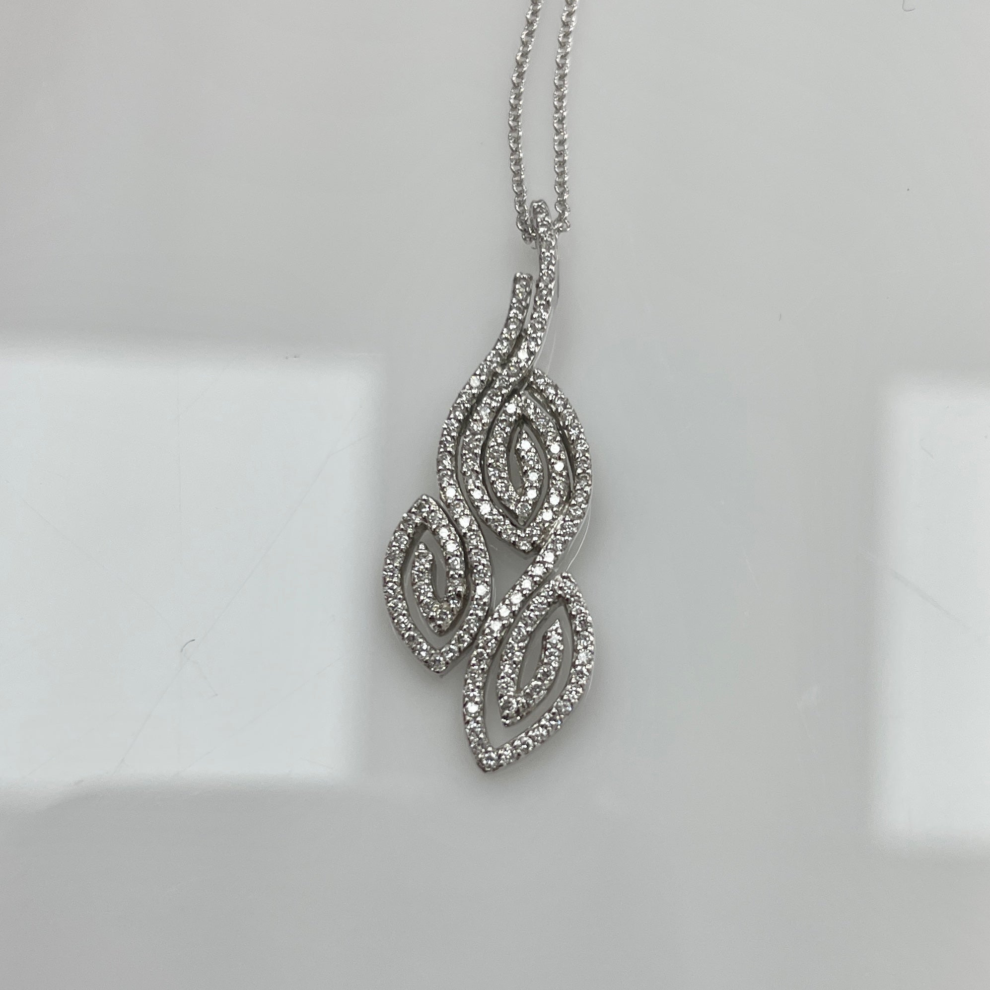 An intricately designed pendant with 0.44Ct of diamonds set in 18K white gold. 
