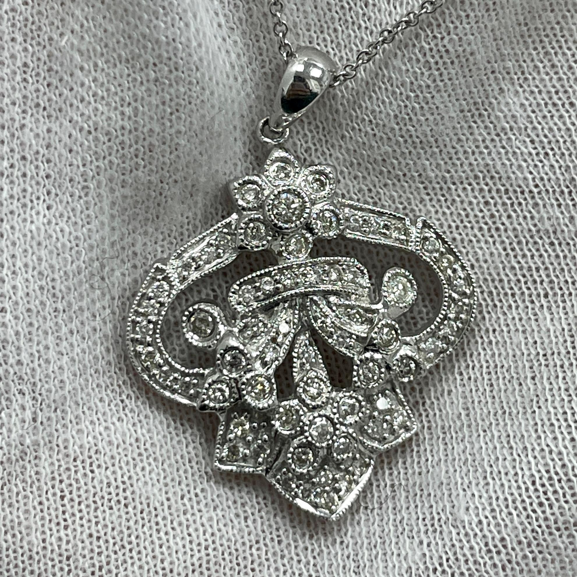 An intricately designed pendant with 0.56Ct of diamonds set in 18K white gold. 
