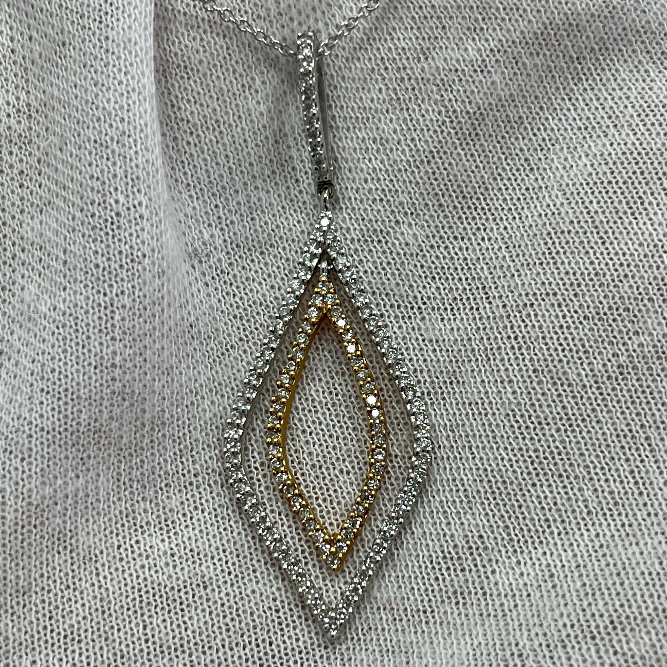 An intricately designed pendant with 0.56Ct of diamonds set in 18K white and yellow gold. 