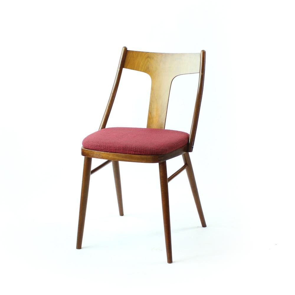 Beautiful set of 4 chairs with unusual shape of backrest. Produced in Czechoslovakia in 1960s, the chairs are in very good original condition. The seat is upholstered in an original darker pink color which looks very classy in the combination with