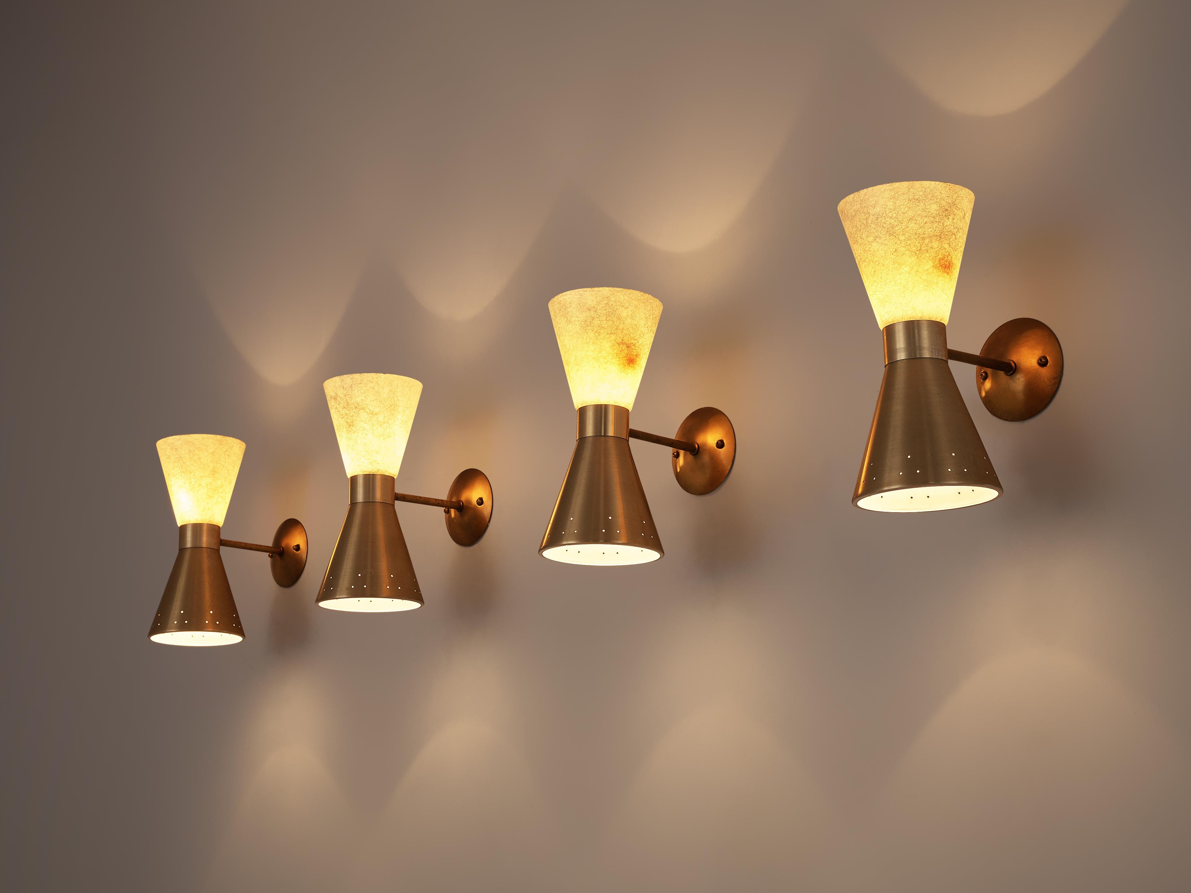 Wall lights, brass, fiberglass, Europe, 1950s

With two cone-shaped lampshades these wall lights shine up and down. One cone is made of perforated brass while the other one features an off-white shade in structured fiberglass. When switched on, the