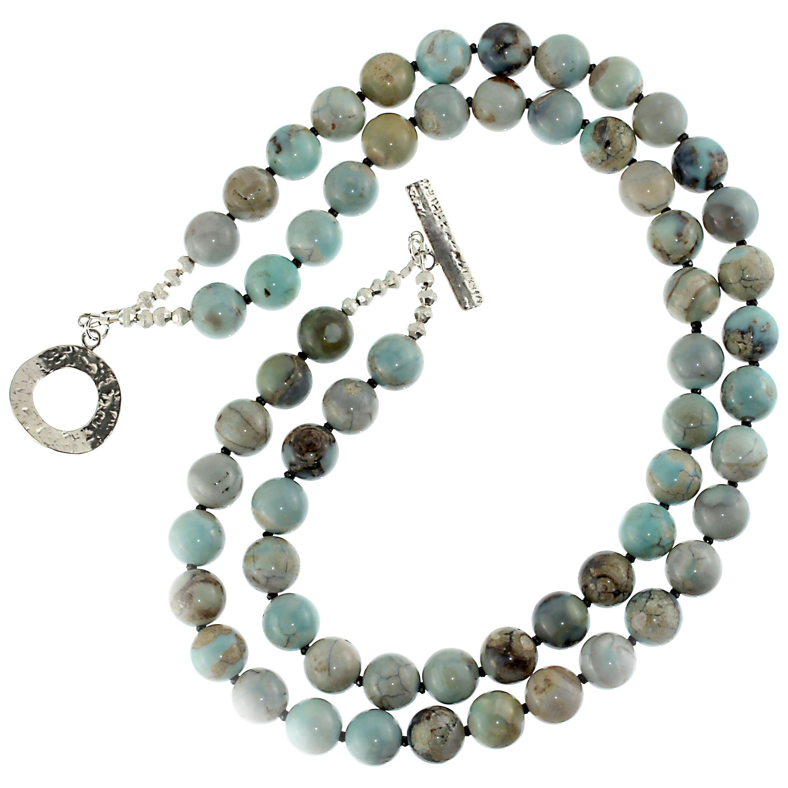 Hand crafted two strand necklace of highly polished Dragon Skin Jasper accented with sparkling black Spinel. This lovely sea blue-green Jasper is mottled with beige and brown. These 12 MM beads are each unique and interesting. This unique necklace