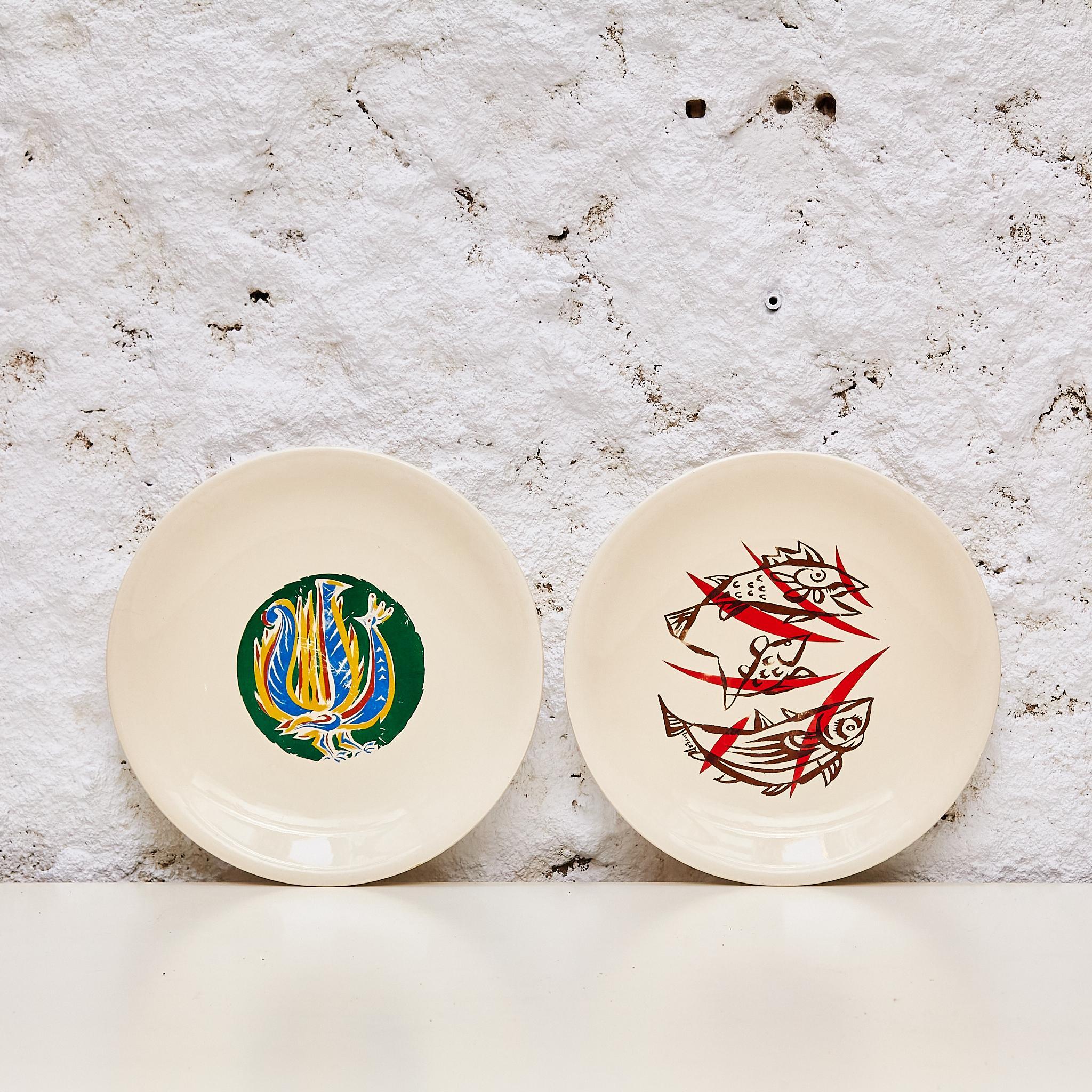 Experience refined craftsmanship with this captivating set of two plates by Marc Saint-Seans, originating from 1950s France. Each plate is graced with the artist's signature and stamp, embodying the timeless allure of artistic creation.  Measuring