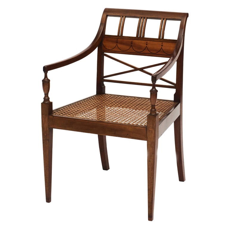 Elegant empire armchair in mahogany and satinwood. Satinwood and dark wood marquetry inlaid.
Seat with original wicker. New upholstered seat cushion.
Measures: Seat height 41 cm.
Copenhagen, approx. 1810.
  