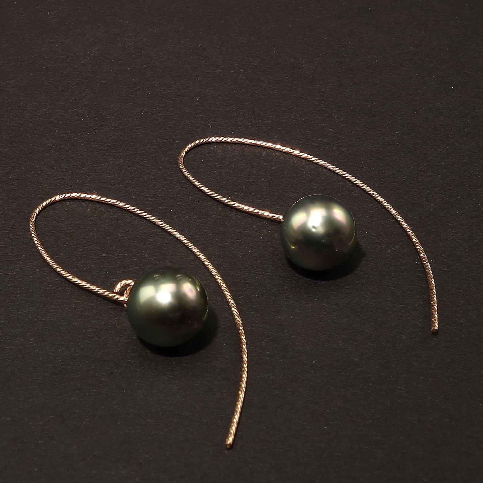 Handmade earrings of gorgeous round iridescent gray pearls dangling from rose Sterling Silver long hooks.  The iridescent gray pearls have flashes pink and green.  The Sterling Silver hooks are twisted and sparkly.  These pearl earrings are