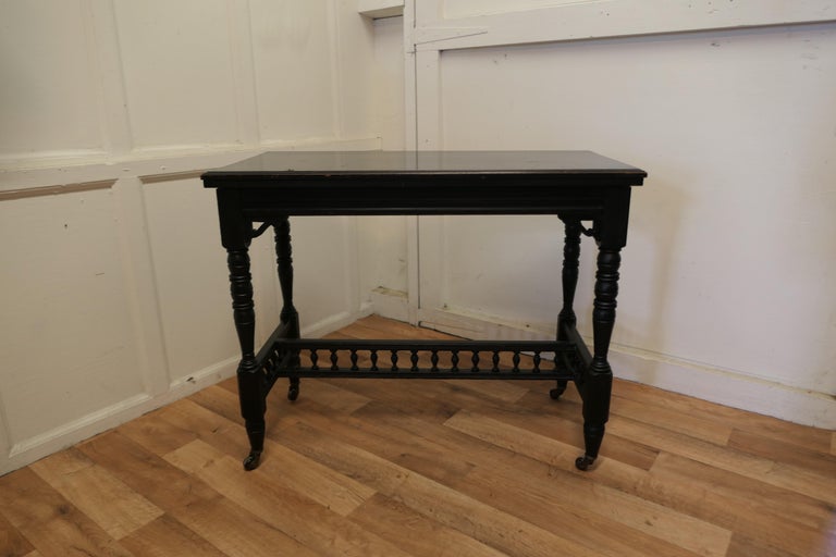 Elegant Ebonised Occasional Card hall table

 This stylish Victorian piece has an ebonised finish which is a smooth slightly shiny black finish which was made popular after the death of Prince Albert, pieces like this are often called mourning