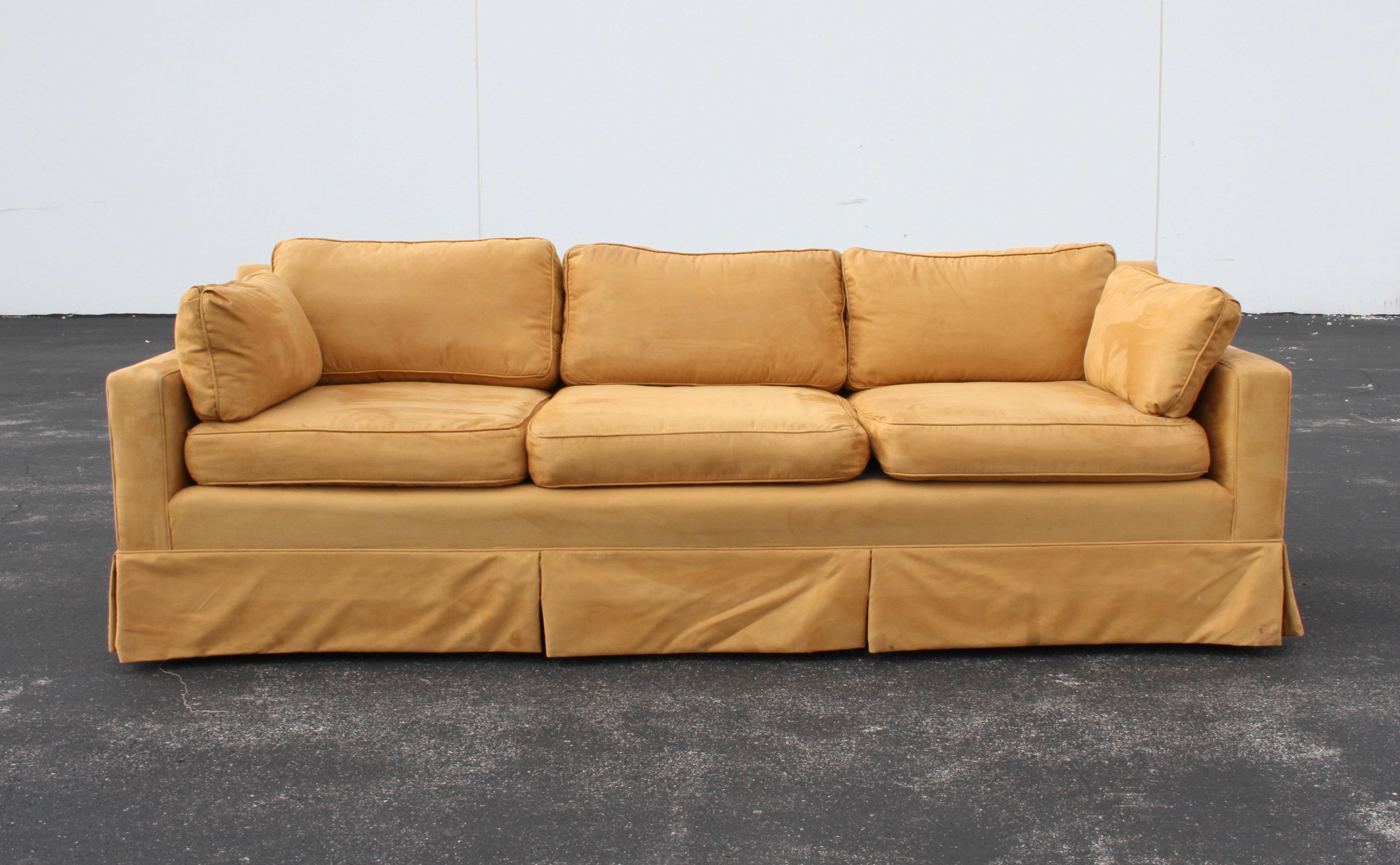 Elegant Mid-Century Edward Wormley for Dunbar sofa with skirt, but on sculpted mahogany legs. You can't beat the quality of a Dunbar sofa, built to last. 
Sofa has older reupholstery and newer new foam, but both are in need of reupholstery again.