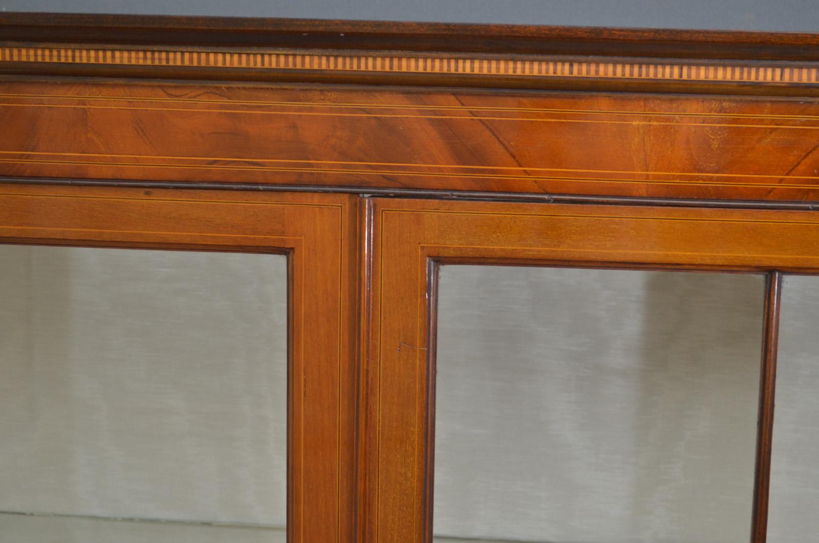 Sn4184, a tall and elegant Edwardian mahogany and inlaid display cabinet / china cabinet, having moulded cornice above satinwood dentil inlaid frieze a pair of satinwood inlaid doors fitted with original working lock and enclosing relined interior