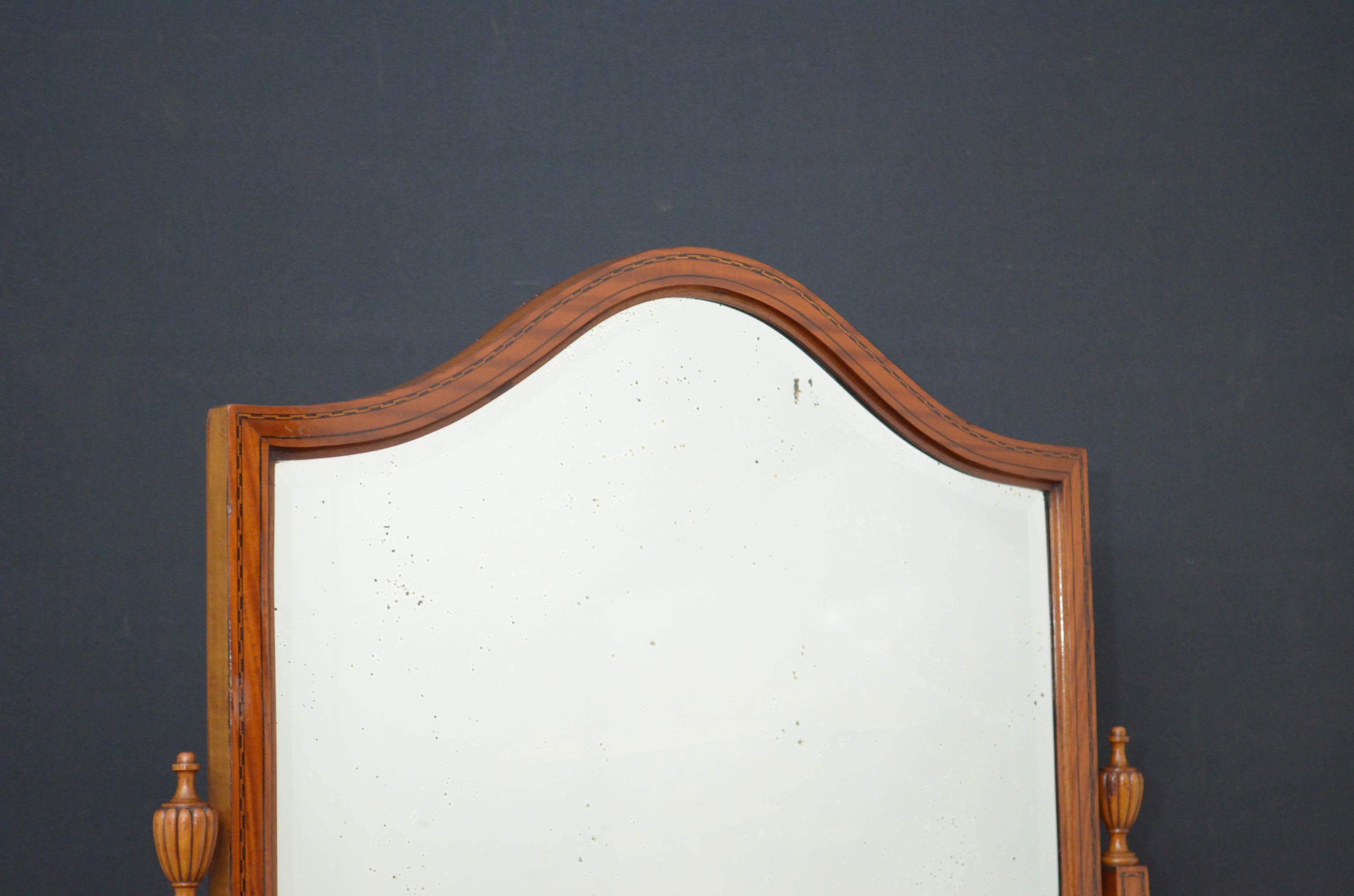 Sn4752, an elegant Edwardian satinwood and inlaid, shield shaped cheval mirror, having original bevelled edge mirror with some silvering in inlaid frame and finely inlaid supports with original fluted finials to top and sun inlays to base, standing