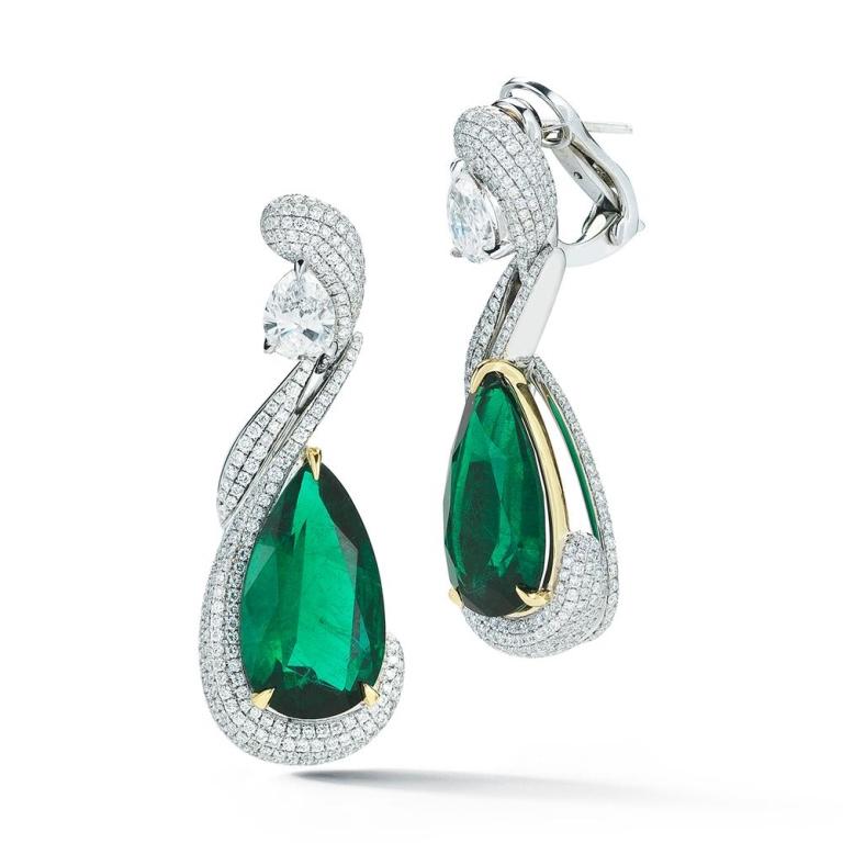 ELEGANT EMERALD AND DIAMOND EARRINGS A picture of elegance defined, these matched Emerald pears are encircled by winding diamond pave Item: # 02335 Metal: 18k W / Y Lab: Gia Color Weight: 13.94 ct. Diamond Weight: 4.28 ct.



