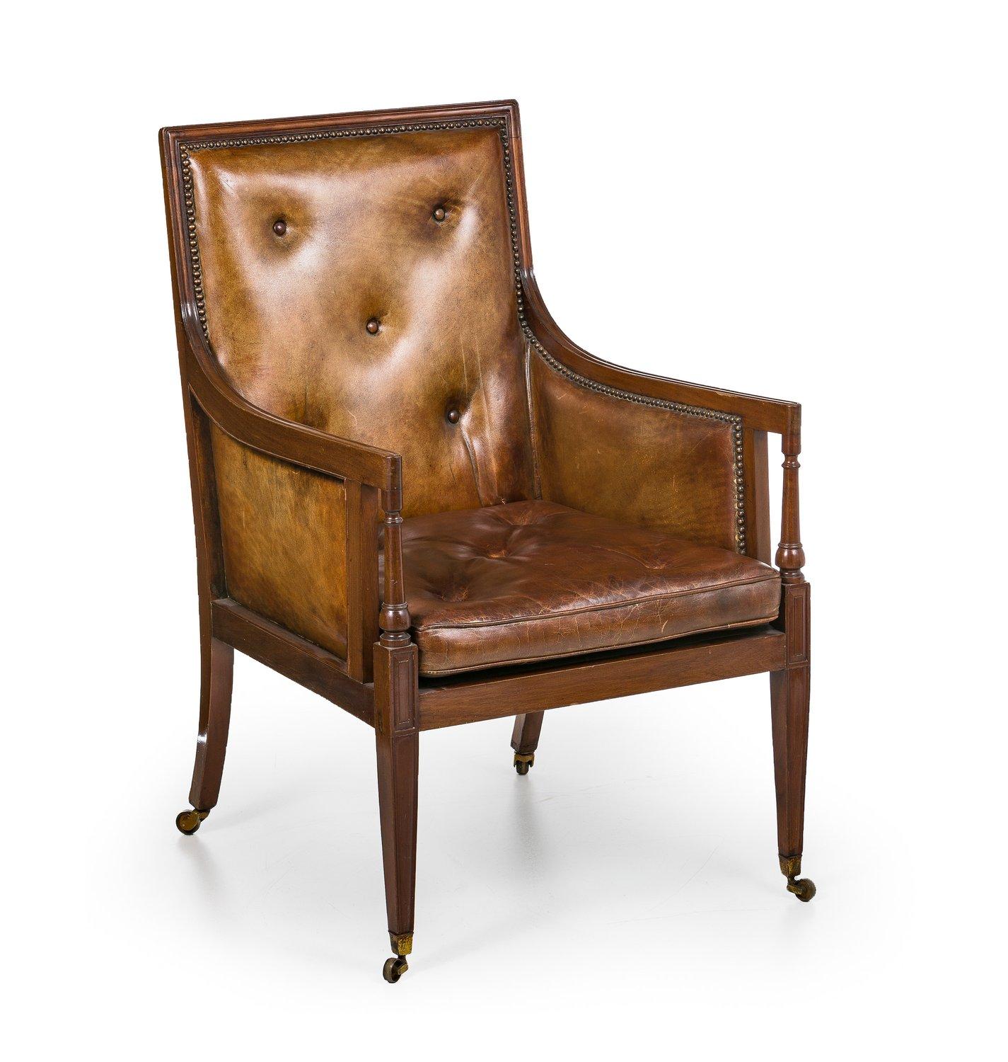 Lounge chair
England
Mahogany. Simple profiled frame with high backrest and armrest with column supports. Leather upholstery and leather cushions. On brass casters.

                    