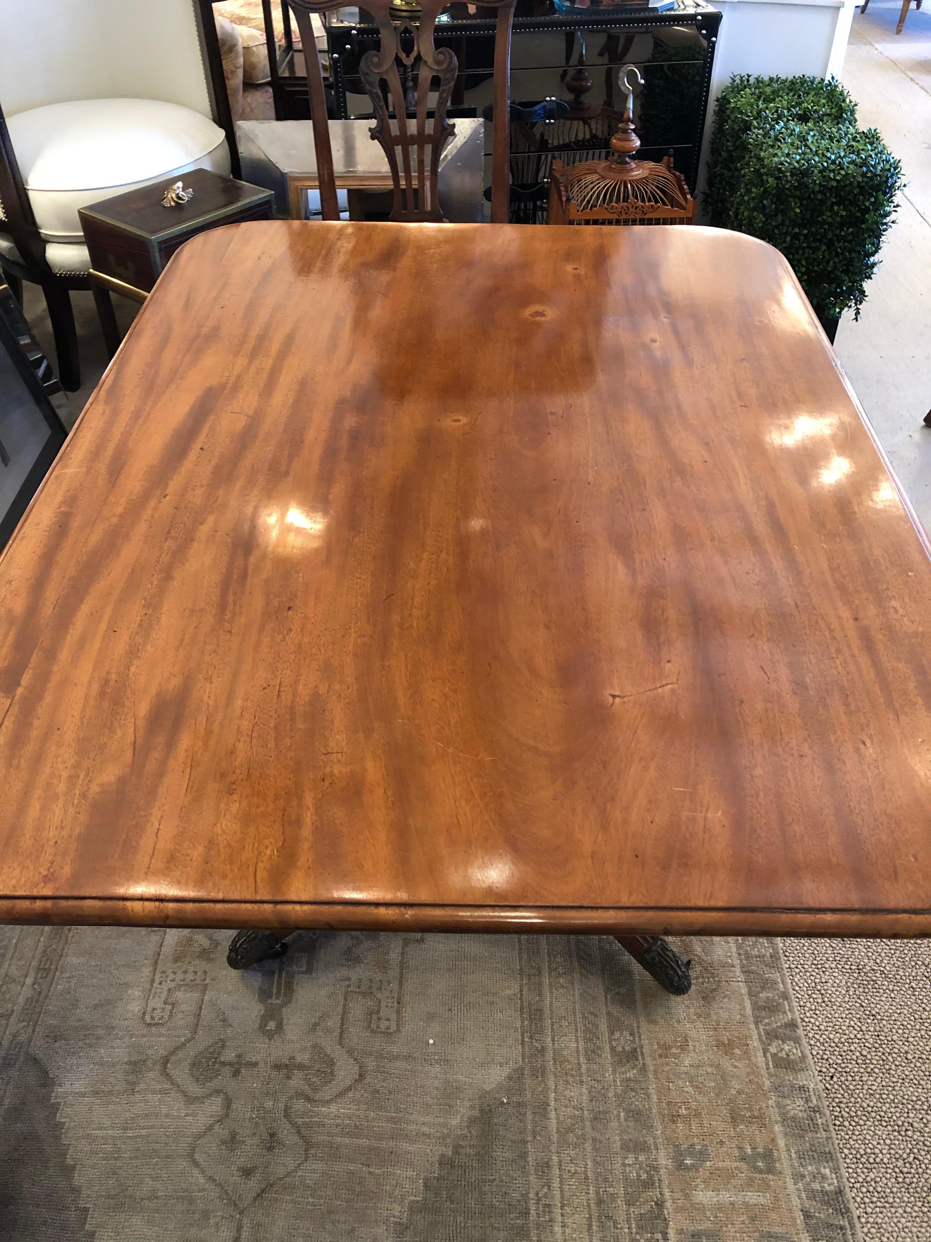 Refined antique faded mahogany rectangular small dining table having turned pedestal base on 4 splayed legs with casters. Wonderful as an elegant breakfast table or small dining table.
When top is in upright vertical position, 61.5 H.