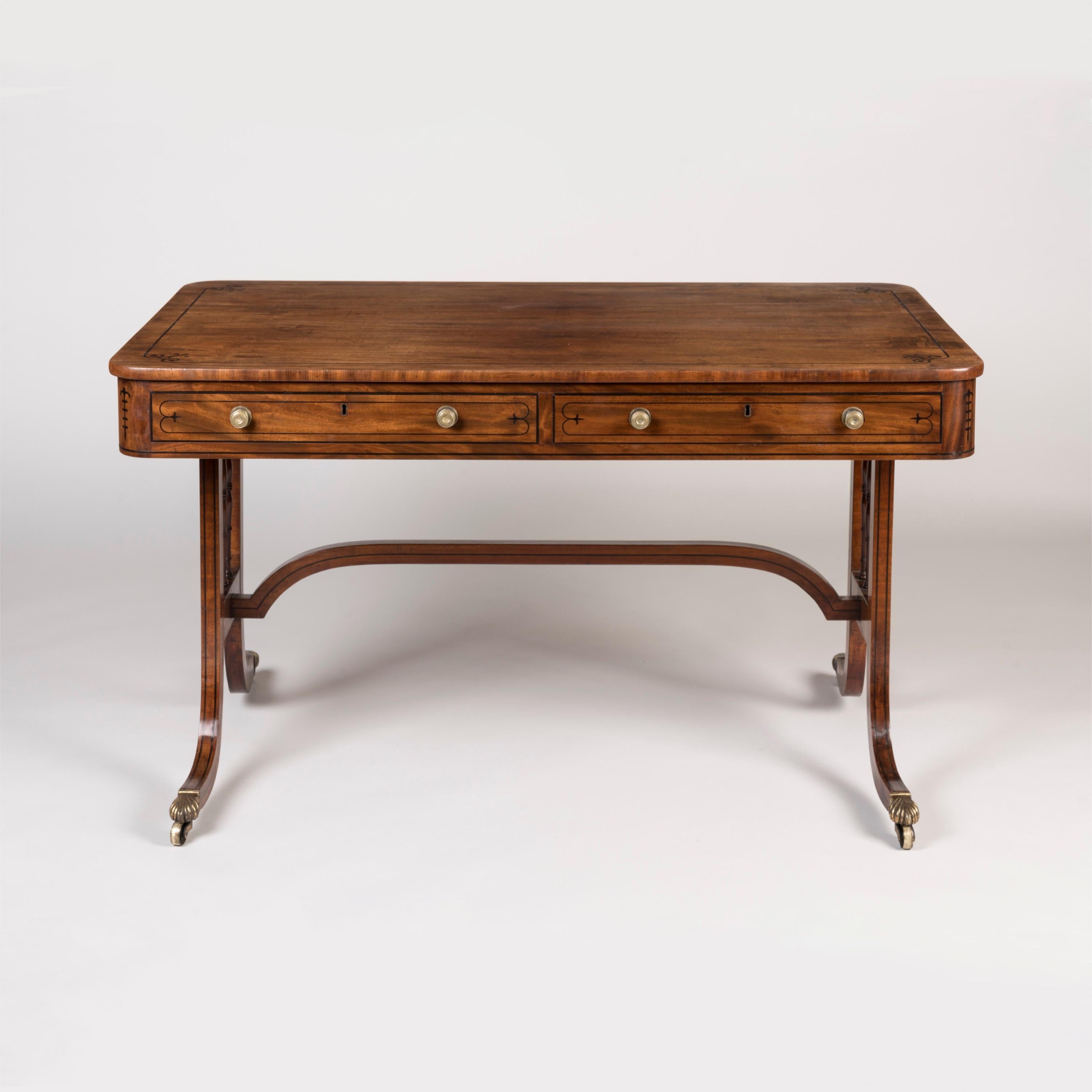 An Elegant Regency Period Table 
Attributed to Gillow

Constructed in a striking flamed Honduran mahogany: rising from brass castor shod swept and ebony strung legs, the ends housing vertical frames enclosing triple tapering and turned spindles and