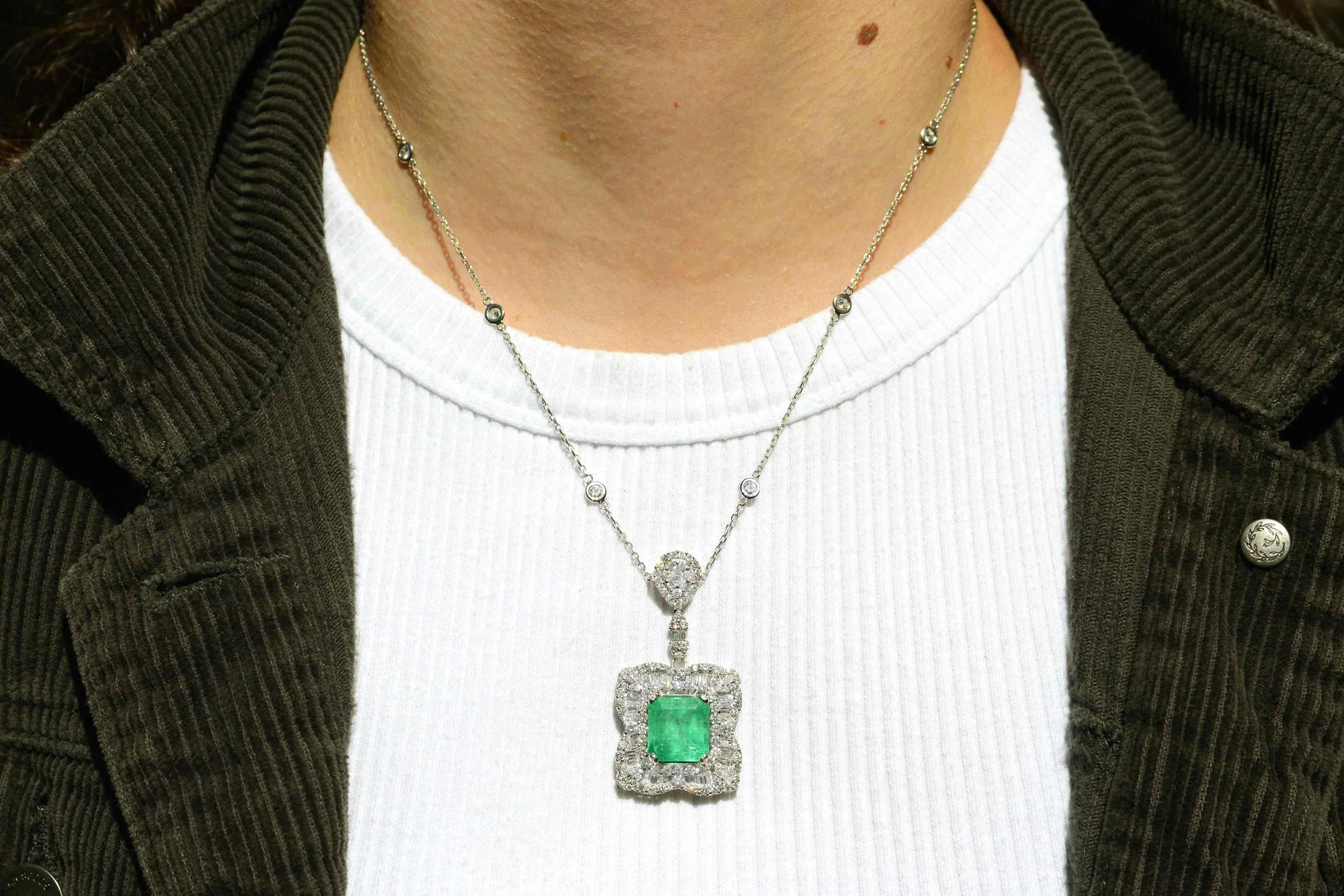 The Meagan emerald and diamond pendant necklace makes a glorious statement. The central gemstone of nearly 8 carats glows with a vivid green fire from within its soul and is smartly surrounded by 3 carats of glittering and fiery baguette and round