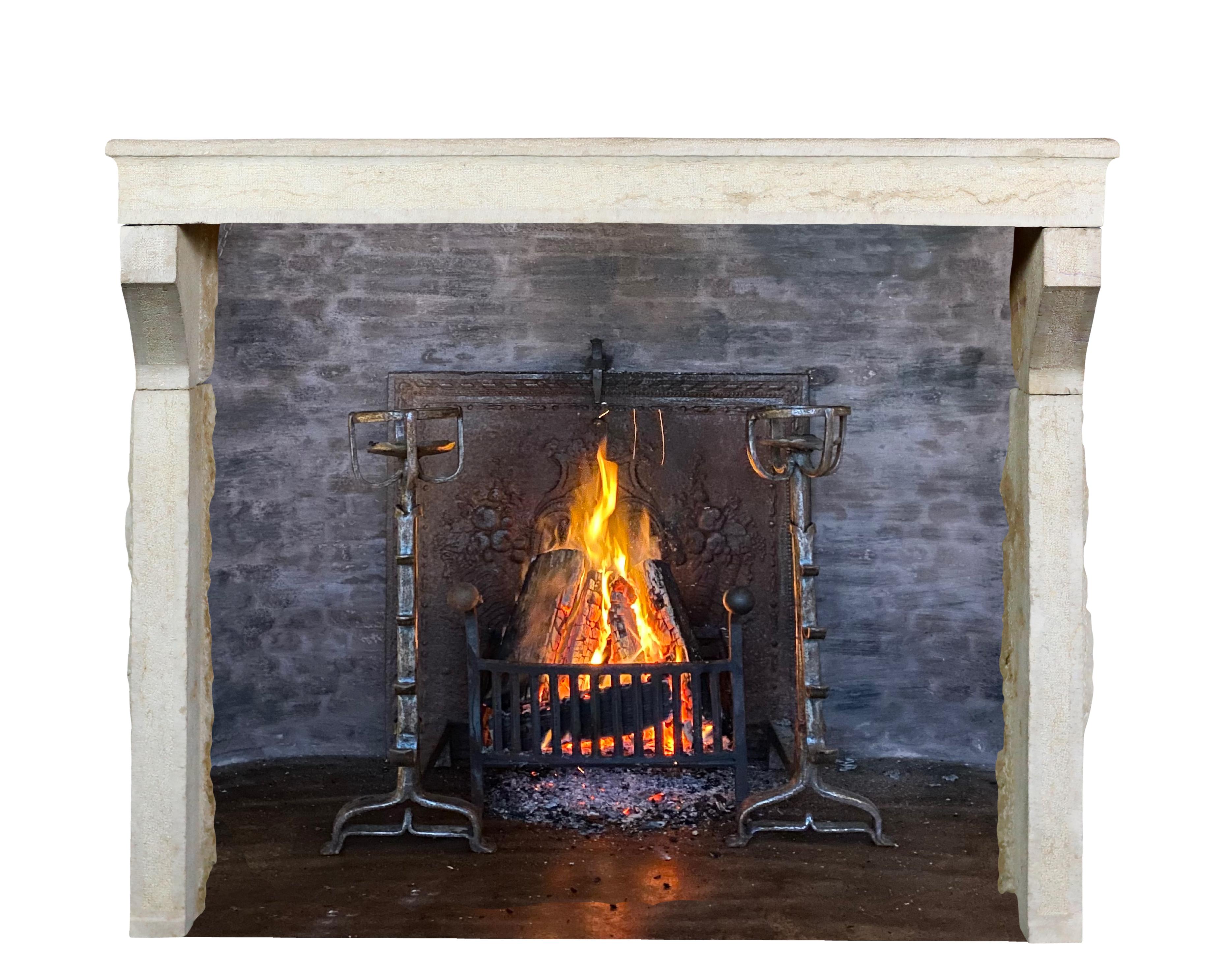 Elegant monochrome beige limestone French farm style fireplace surround in great condition. This European fireplace mantle is simple and has a timeless style for contemporary eclectic interior project. With over 6 Feet wide it has rather unusual