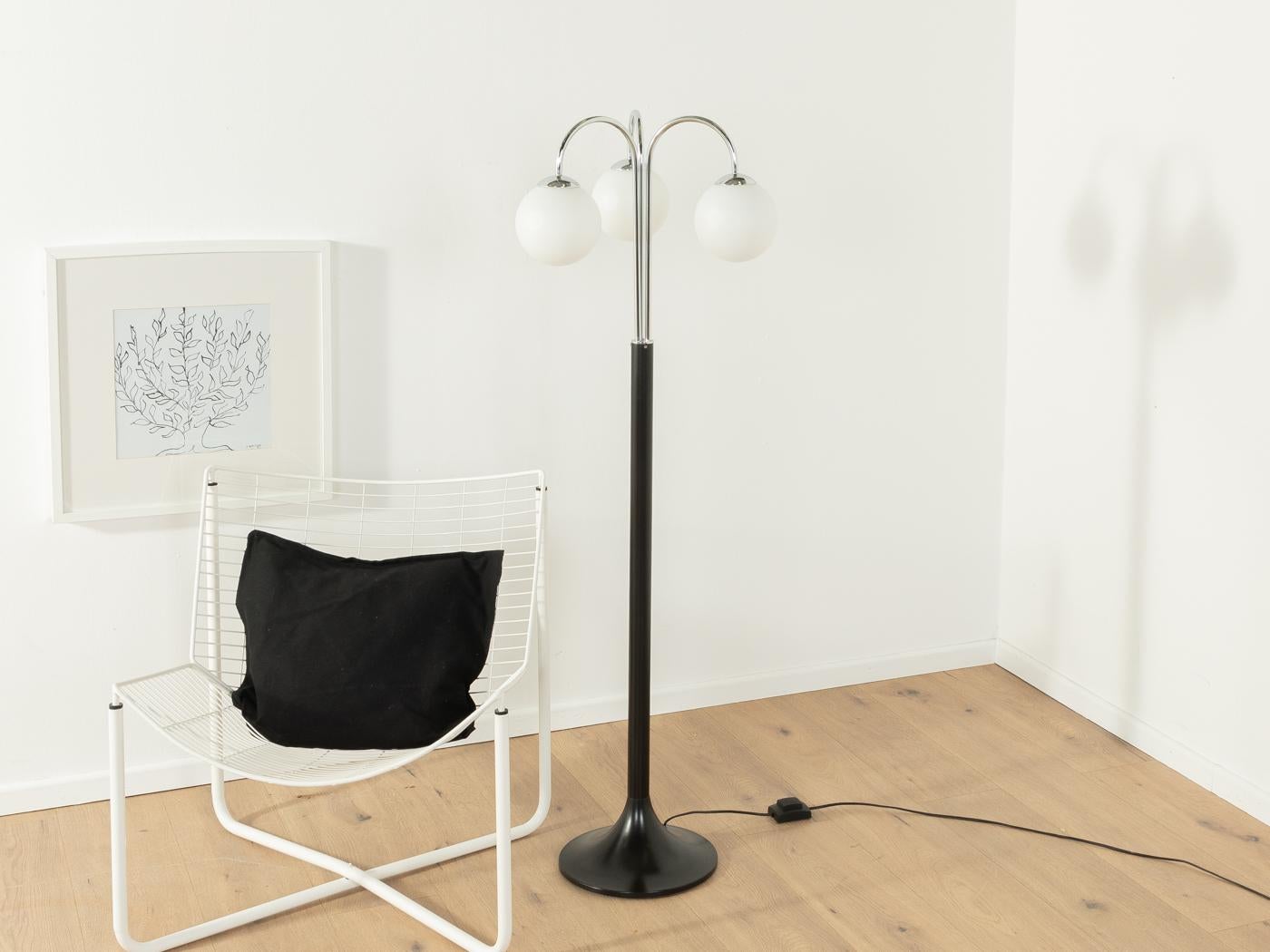 Elegant floor lamp, Mod. HARMONY, by Ikea from the 1970s in the style of Art Déco. High-quality partly chromed metal frame and black plastic base and three frosted glass bulbs.

Quality Features:

    very good workmanship
    high-quality