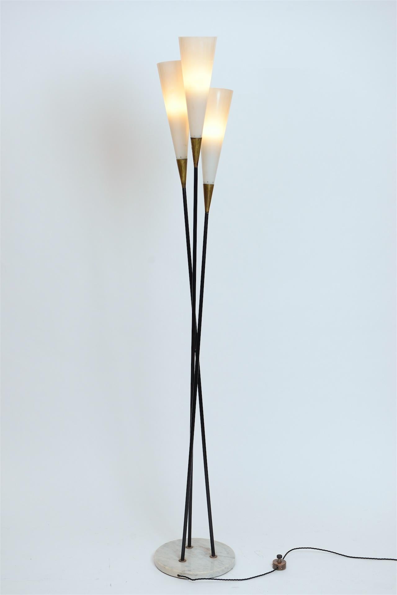 Elegant floor lamp with three Lucite shades, black lacquered brass and brass foot switch. 
Marble base

Probably designed by Guiseppe Ostuni and manufactured by Oluce.

 