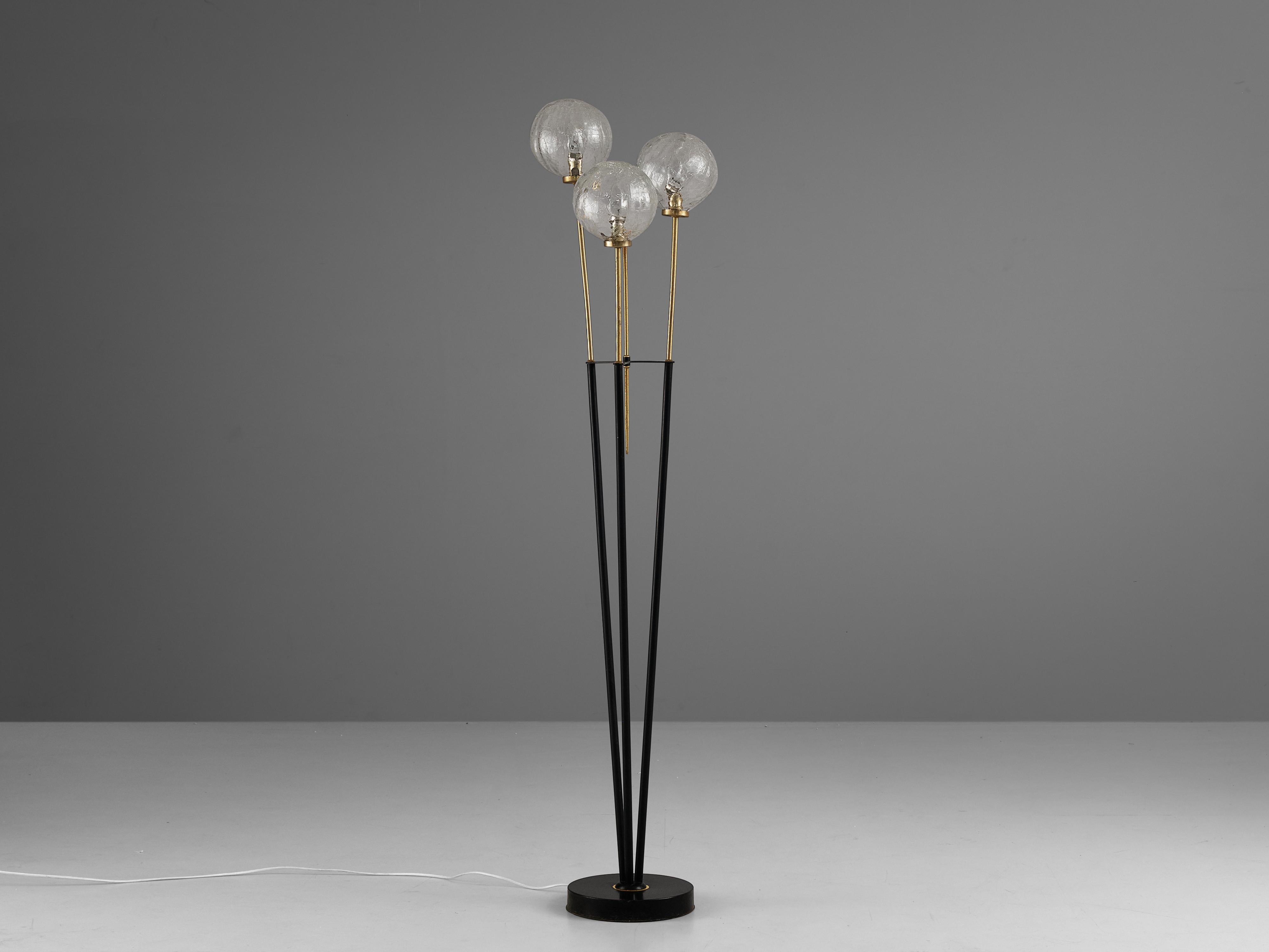 Floor lamp, brass, glass, Europe, 1970s

This elegant floorlamp consists out of three sleek, black legs that to brass. Every leg holds one glass sphere. These three spheres are all structured, creating a stunning light partition. Due to the