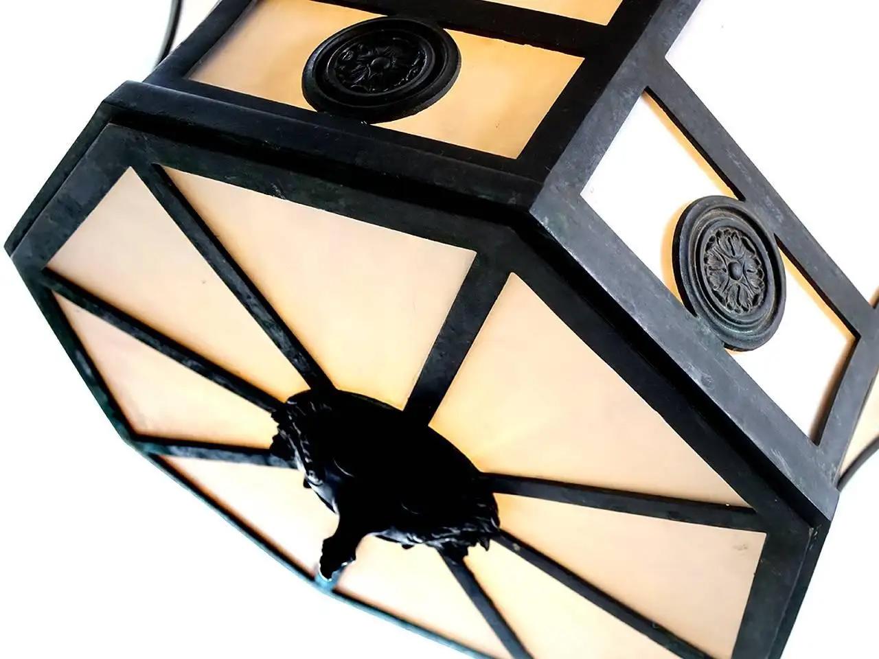 This is a large bronze formal chandelier that is also clean and simple. It gives off a nice warm glow and has a look that will fit with most styles. This is the type of important looking lamp mostly found in office building lobbies, banks and