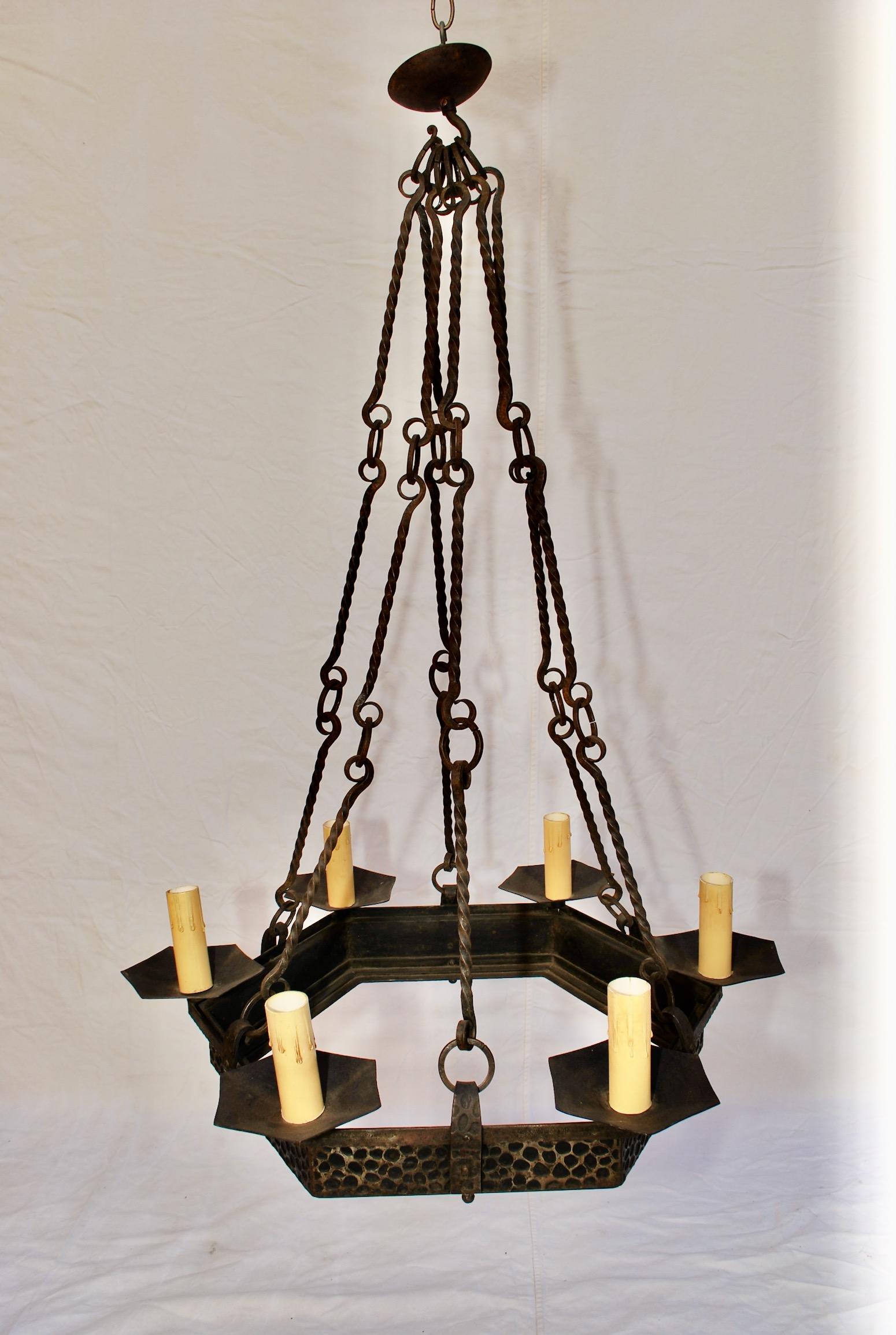 A beautiful all hands made wrought iron chandelier, the patina is much nicer in person, the height can be a little shorter by removing one link of chain.

 